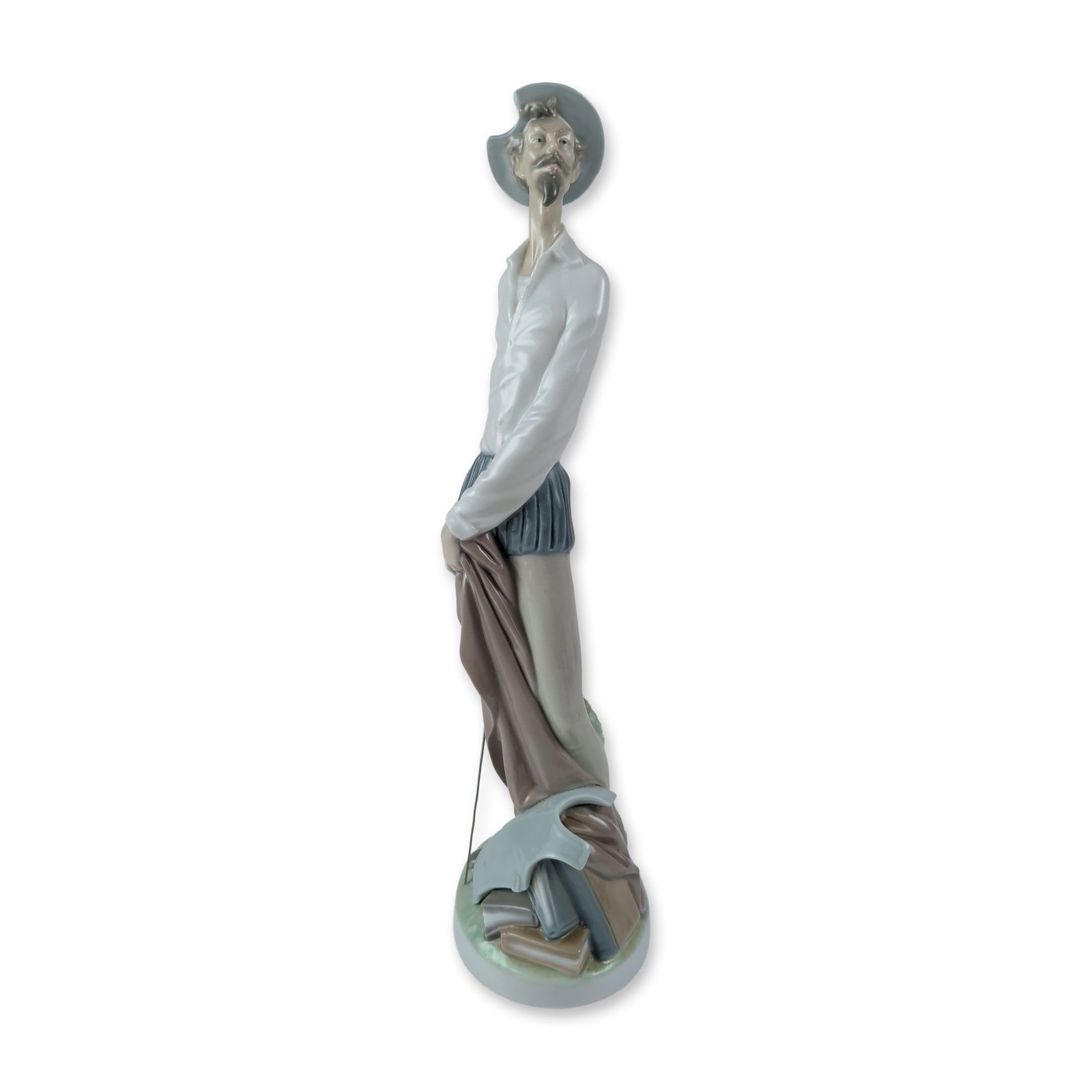 Lladro Don Quixote Glazed Porcelain Figurine 1004854: Lladro figurine, model 1004854, titled Don Quixote Standing Up. The glazed porcelain sculpture depicts the character in a tall, slender pose, wearing a white shirt, blue breeches, and a basin helmet. 