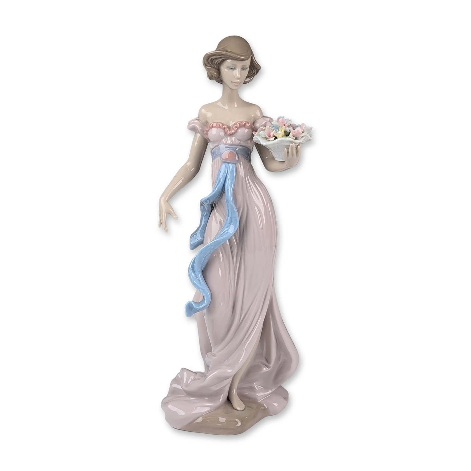 Lladro Glazed Porcelain Figurine, Spring Flirtation 01006365: Lladro (Spanish). Garden Song glazed porcelain figurine, designed by sculptor Regino Torrijos. The piece depicts a slender woman in a flowing pink gown with a ruffled bodice and a trailing blue sash, 