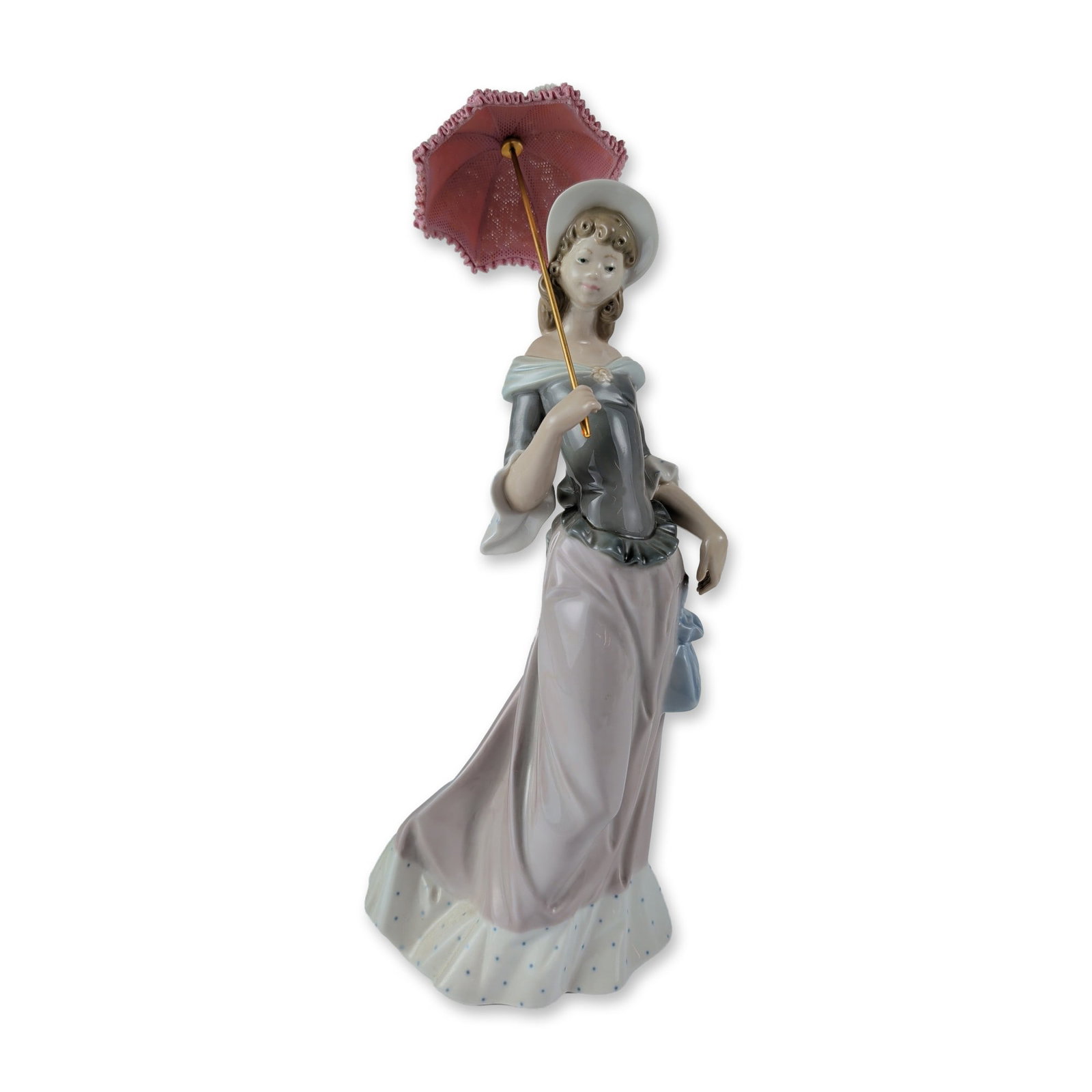 Lladro Porcelain Figurine, Walking 1005003: Lladro porcelain figurine, model 1005003 titled Walking, designed by sculptor Salvador Debon. Glazed porcelain figure depicting a woman in period attire including a grey bodice with a ruffled peplum w