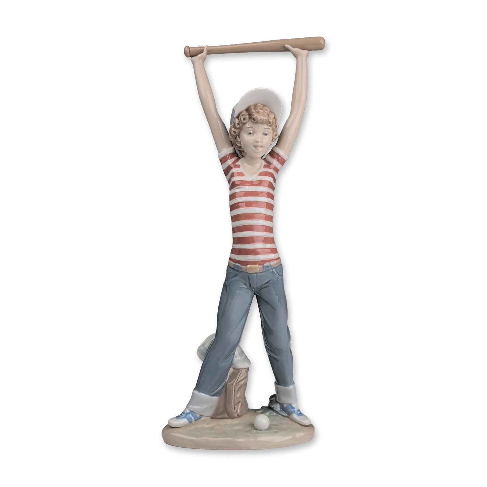 Lladro Porcelain Figurine, Little Leaguer Exercise 01005289: Glossy glazed figure depicting a young boy in a baseball uniform, leaning back with a bat raised overhead. The figure is dressed in a red and white striped shirt, blue jeans, and a white baseball cap.