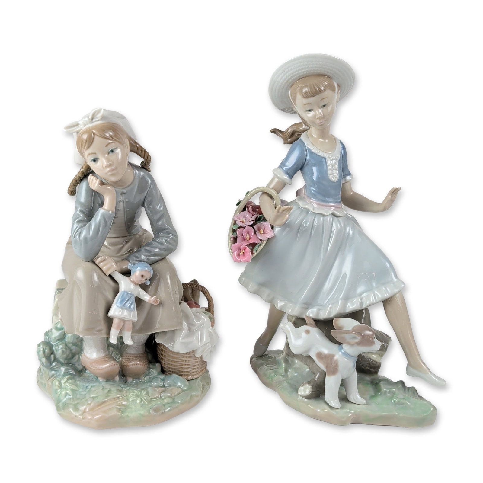 2pc Lladro Porcelain Figurines, Girl with Doll 1211 and Country Lass with Dog 4920: Lladro glazed porcelain figurines from Valencia, Spain. The first example, titled Country Lass with Dog (model 4920), depicts a young girl in a wide-brimmed hat and blue bodice carrying a basket of pi