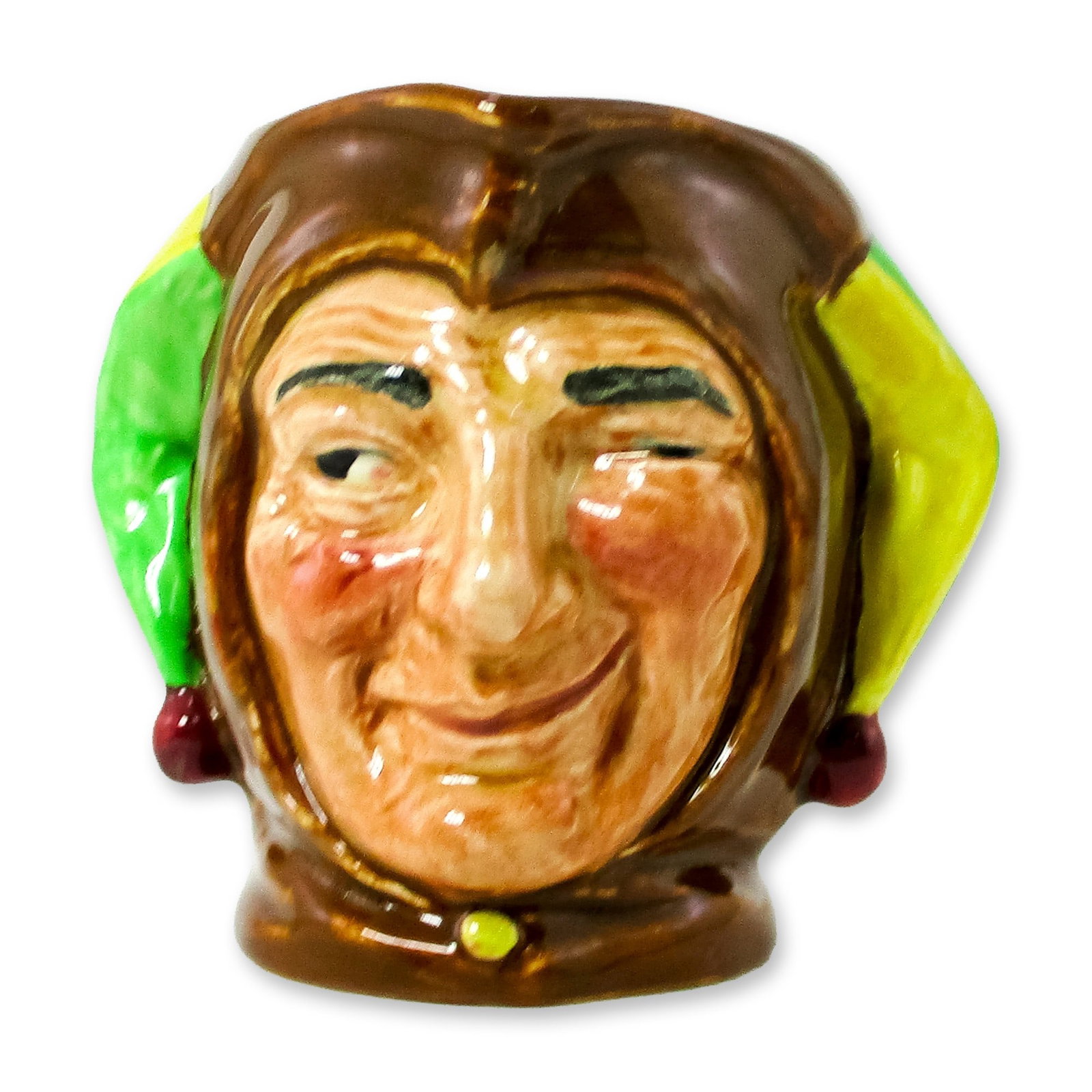 Jester D5556 - Small - Royal Doulton Character Jug: Brown, green and yellow coloration. The green and yellow coloring on either side of the hat may be reversed as a preference of the painter. Royal Doulton backstamp. Artist: Charles Noke Dimensions: 3.