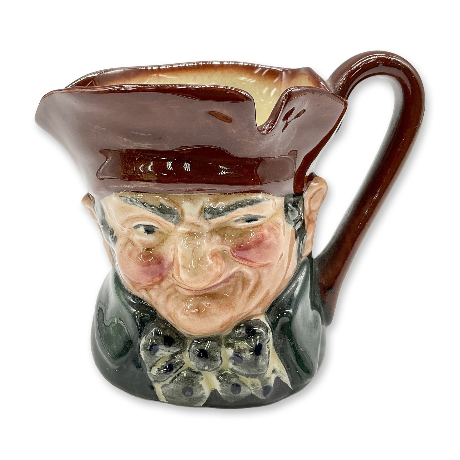 Old Charley D5527 - Small - Royal Doulton Character Jug: Brown hat; dark green coat; blue polka- dot bow tie. Royal Doulton backstamp. Artist: Charles J. Noke Dimensions: 3.25"H Date or Era: 1935 - 1983 Manufacturer or Brand: Royal Doulton Country of Or