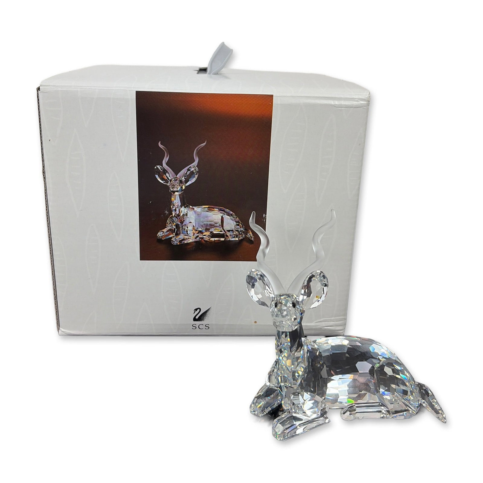 Swarovski Inspiration Africa Signed Crystal Kudu Figurine: Swarovski Kudu figurine from the SCS 1994 Annual Edition Inspiration Africa series, in faceted clear lead crystal with frosted spiral horns and black crystal eyes. Etched with Swarovski swan logo and 