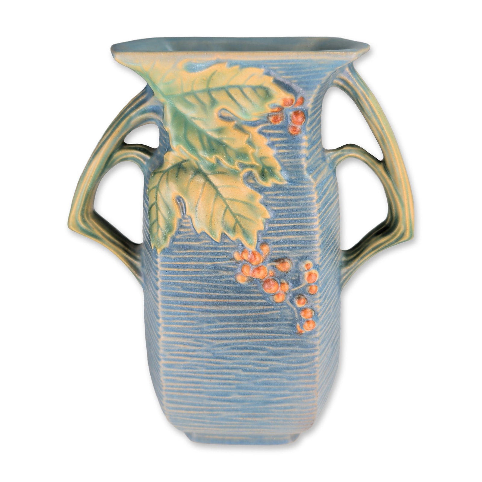 Roseville Bushberry Pattern Blue Art Pottery Vase: Roseville Pottery, U.S.A. Art pottery earthenware vase in the Bushberry pattern, featuring a vertically ribbed ground in a matte blue glaze. The relief-molded decoration depicts bittersweet branches w