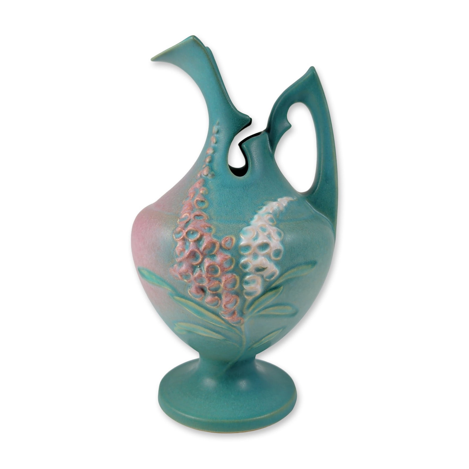Roseville Foxglove Art Pottery Pedestal Ewer: Roseville Pottery, Ohio, earthenware pedestal vase in the Foxglove pattern, featuring matte teal and pink blushed glazes. The form is defined by an asymmetrical flared rim and two integral arching han