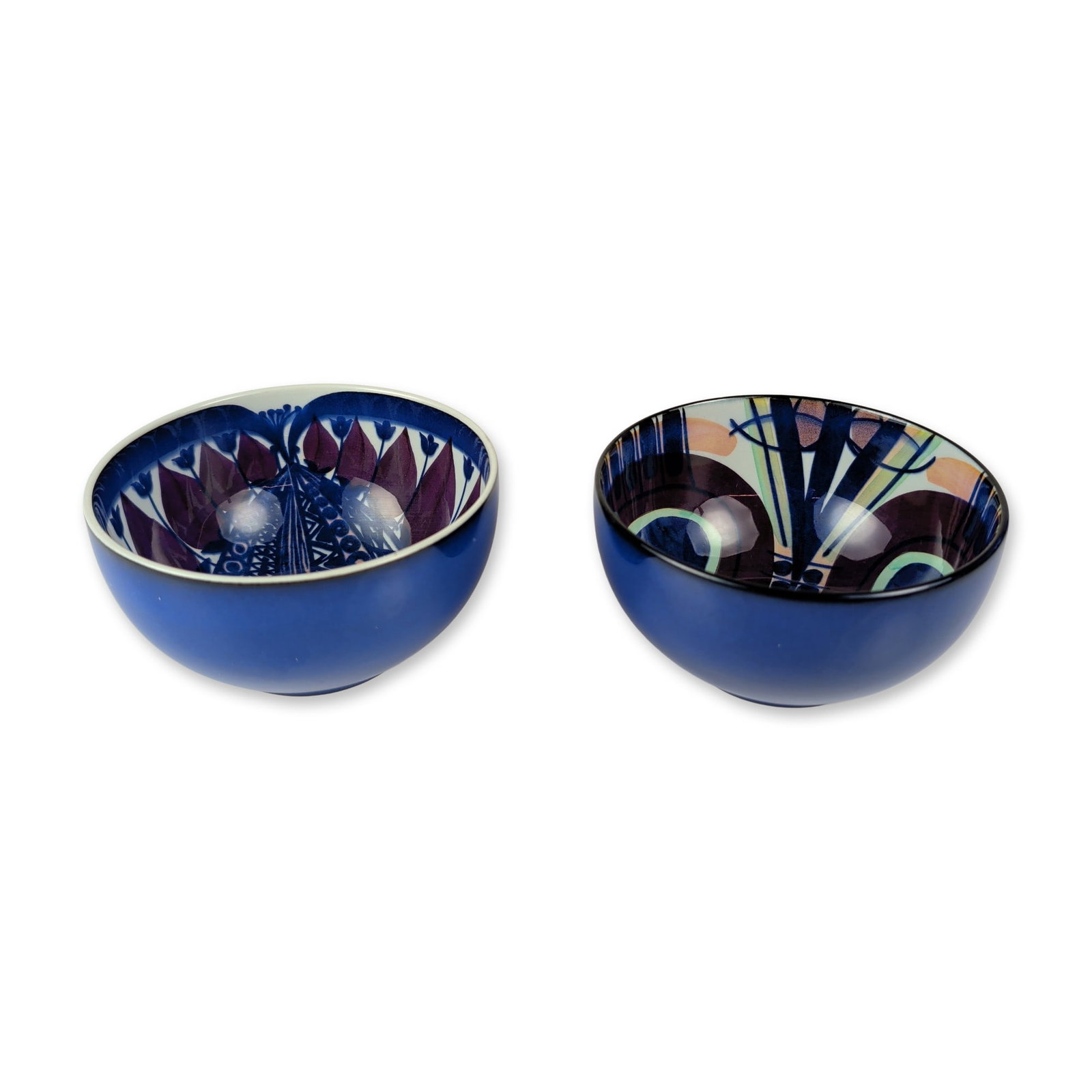 2pc Royal Copenhagen Fajance Ceramic Bowls: Royal Copenhagen fajance ceramic bowls, each constructed of tin-glazed earthenware with a solid matte royal blue exterior and hand-painted abstract interior decoration in shades of indigo, purple,