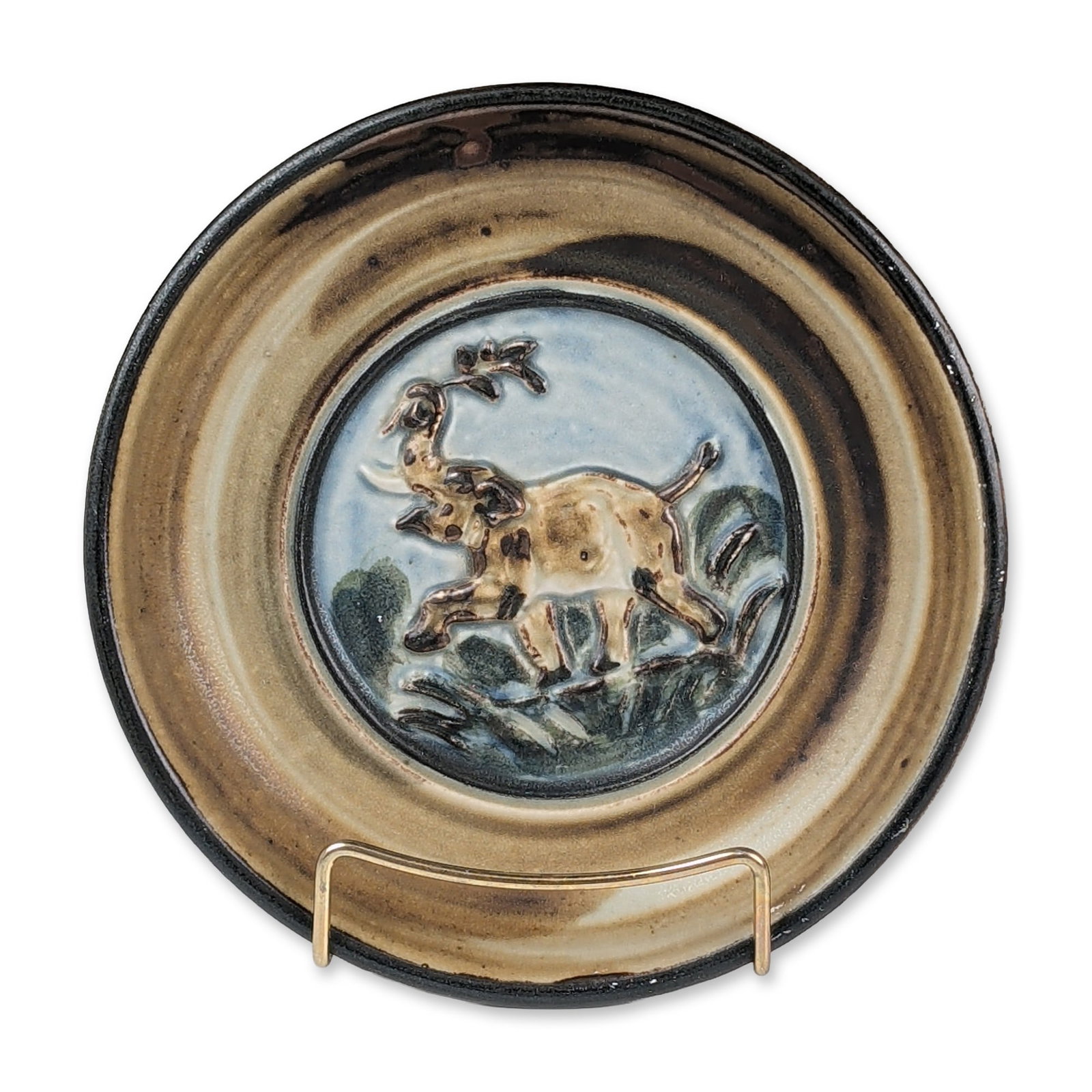 Royal Copenhagen by Knud Kyhn Stoneware Relief Plate: Royal Copenhagen circular stoneware relief plate by Knud Kyhn. The shallow dish features a central relief-molded medallion depicting a stag in a landscape, finished in pale blue and tan glazes. The