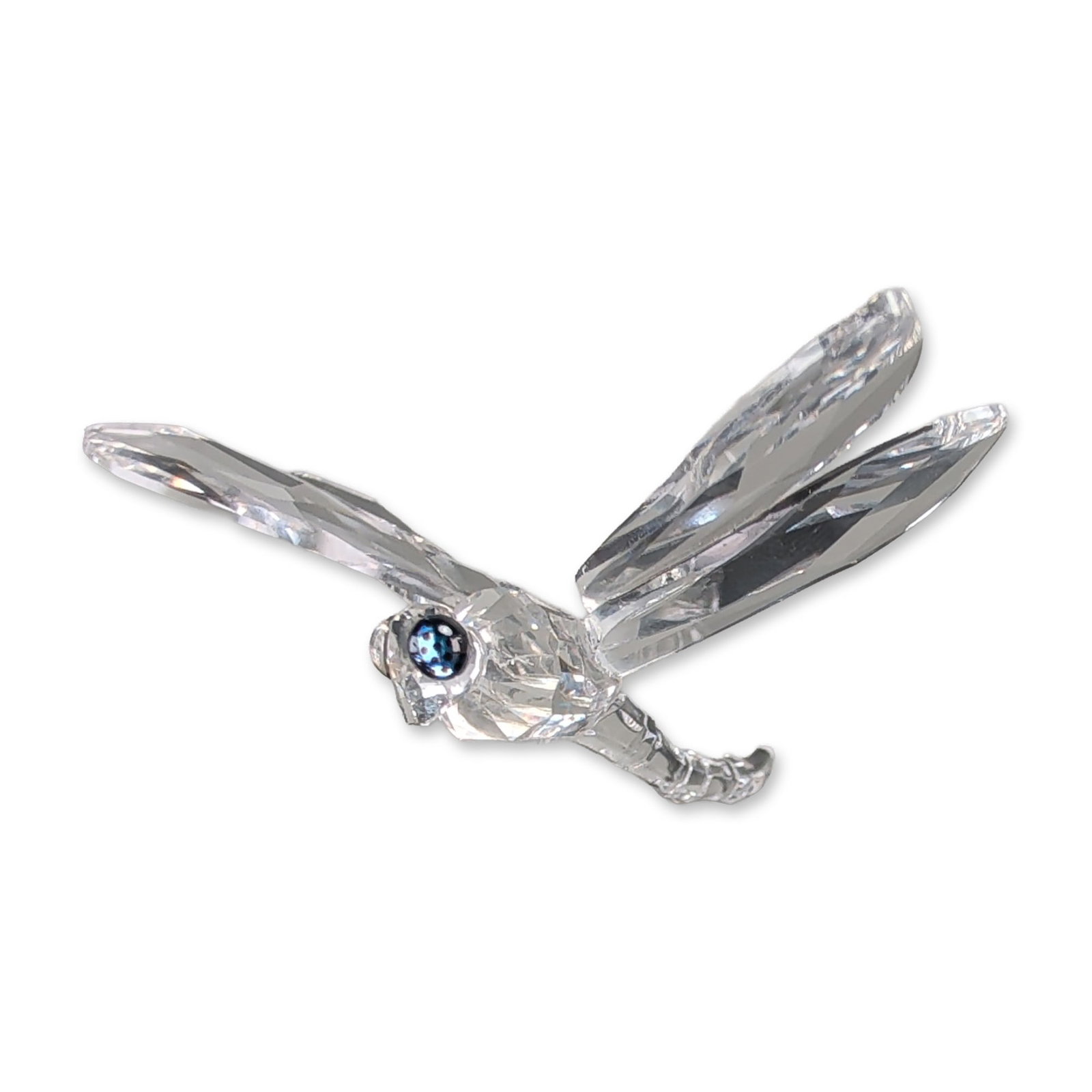 Swarovski Silver Crystal Dragonfly Figurine: Swarovski Silver Crystal dragonfly figurine, model number 190264, in faceted clear crystal with sapphire-blue crystal eyes. The dragonfly is depicted perched on a stylized floral or leaf base featurin