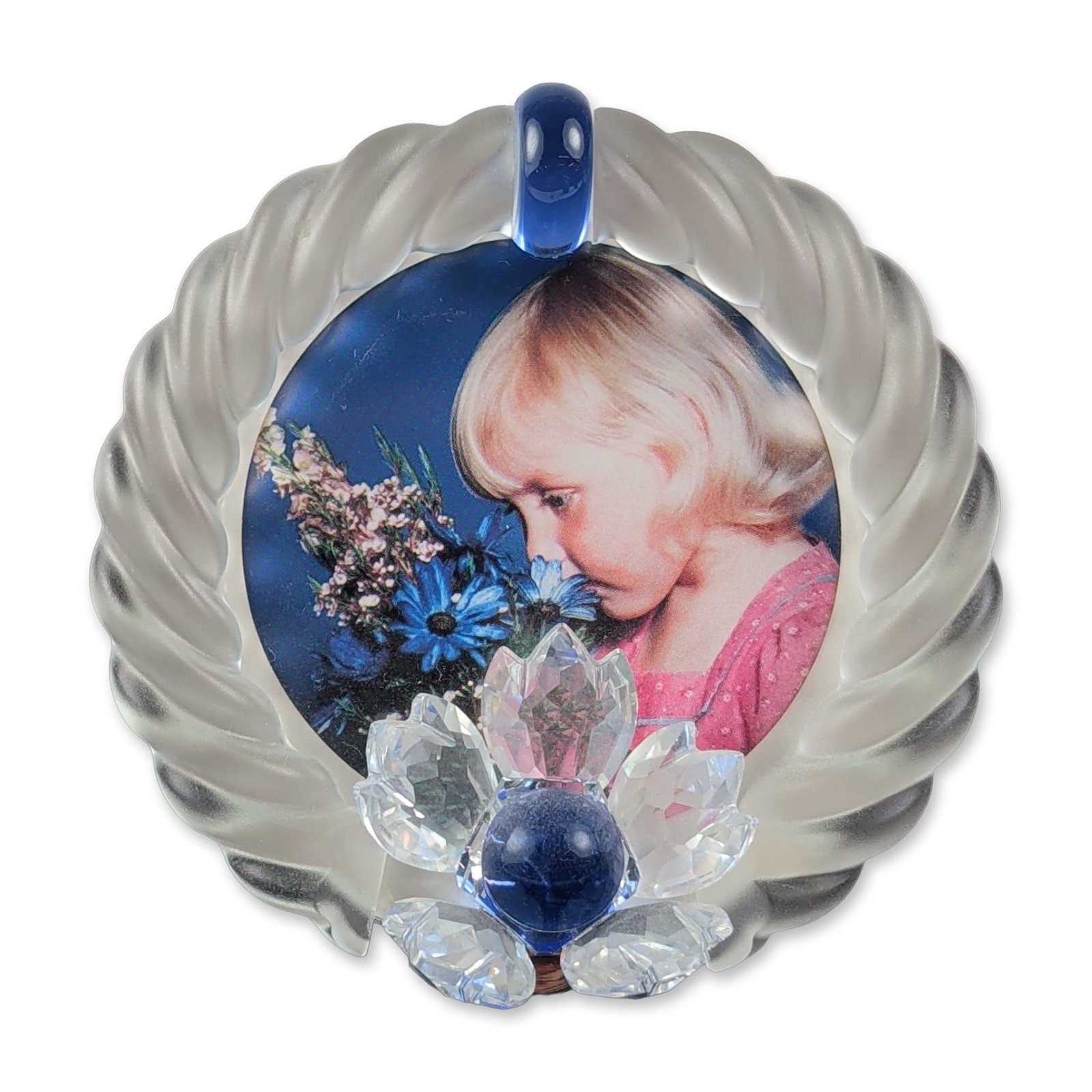 Swarovski Blue Flower Crystal Picture Frame: Swarovski crystal picture frame featuring a circular medallion with a frosted twisted rope border. The decorative front is adorned with a three-dimensional faceted crystal flower centered with a light