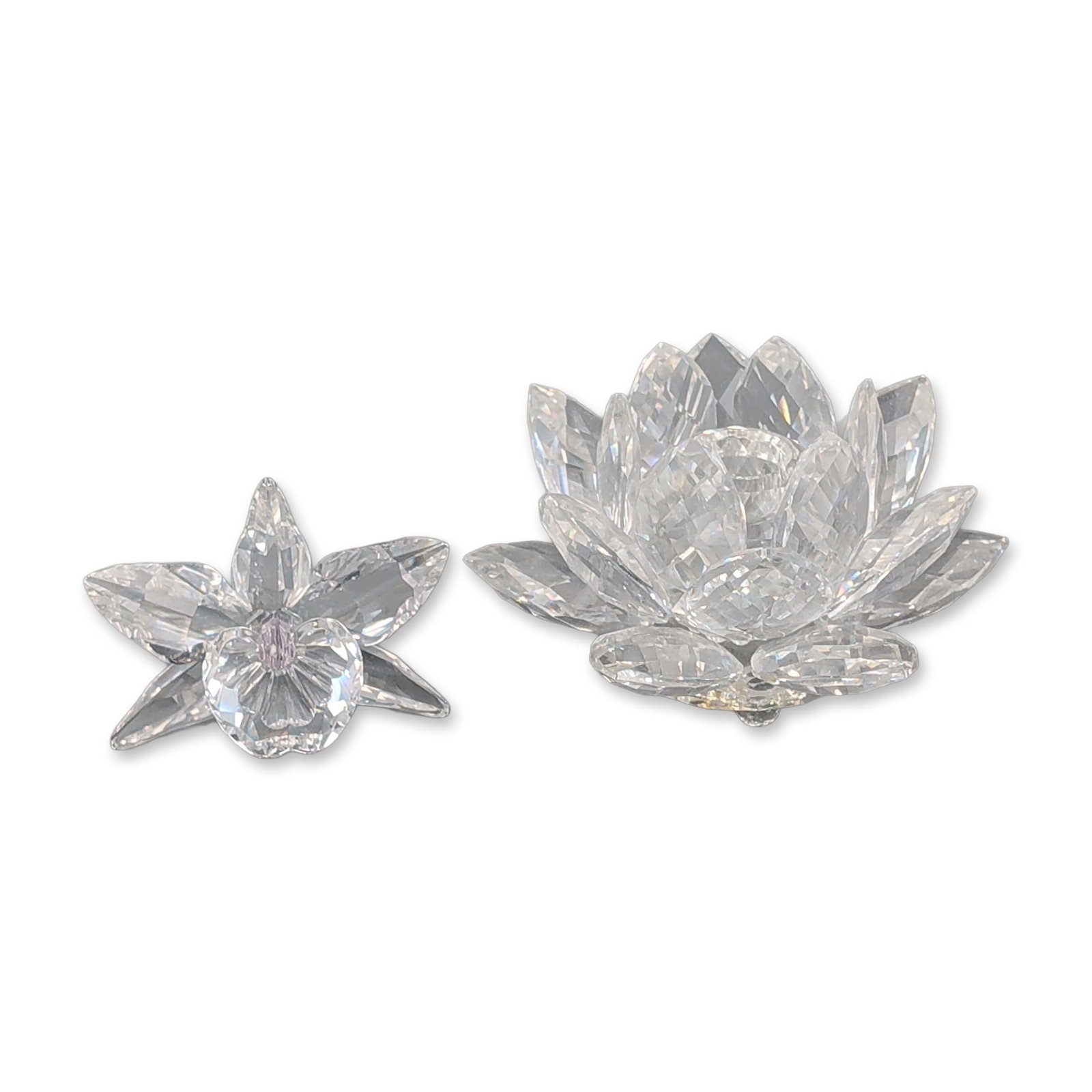 Two Swarovski Silver Crystal Waterlily Candle Holder and Orchid Figurine: Swarovski Silver Crystal faceted lead crystal figurines. Includes a tiered waterlily with three spherical crystal feet and a single flower on a curved faceted stem featuring three petals and a pink-ti