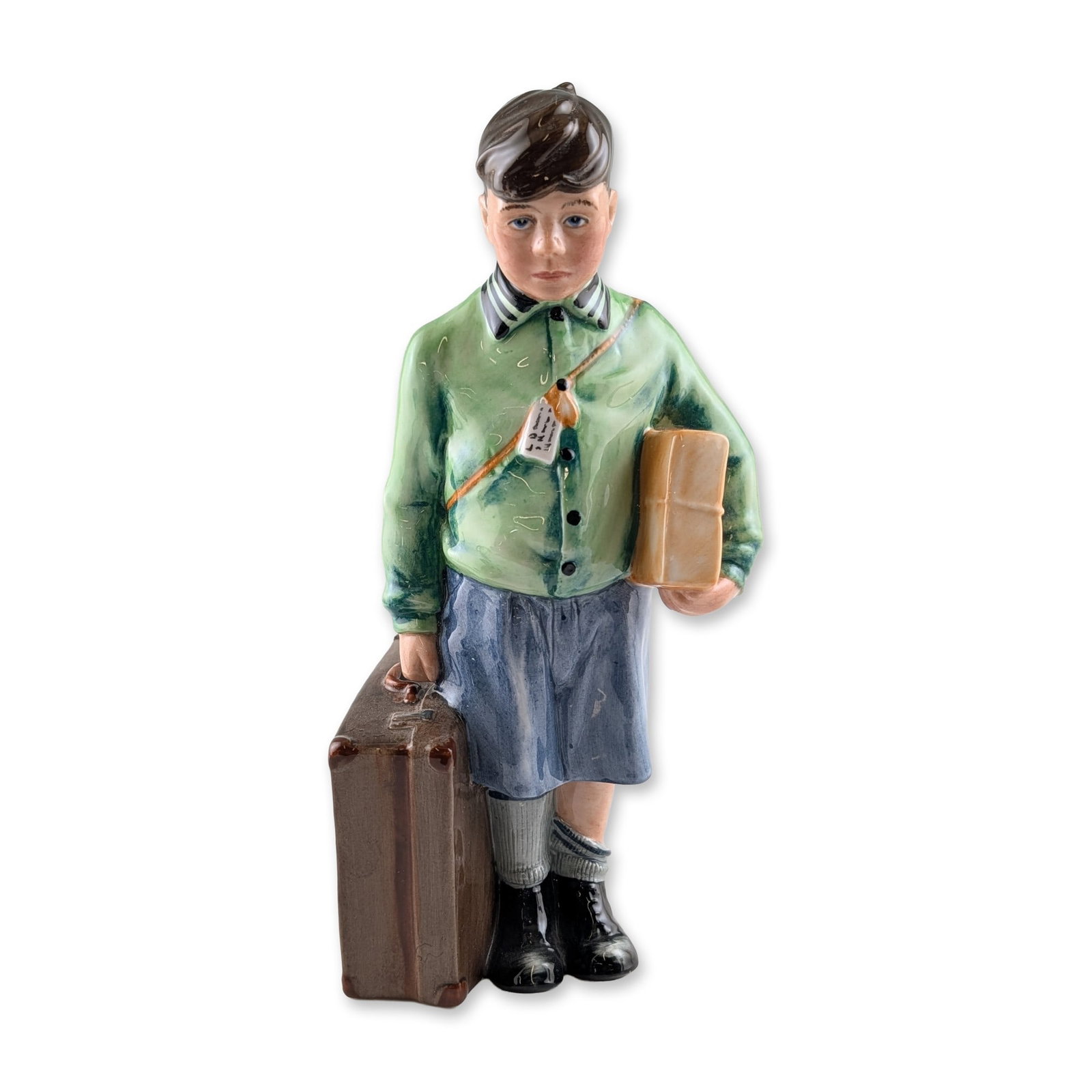 Royal Doulton Boy Evacuee Porcelain Figurine: Royal Doulton polychrome glazed porcelain figurine titled The Boy Evacuee, HN 3202, from the Children of the Blitz series. Modeled by Adrian Hughes and issued in 1988. The figure depicts a young boy i