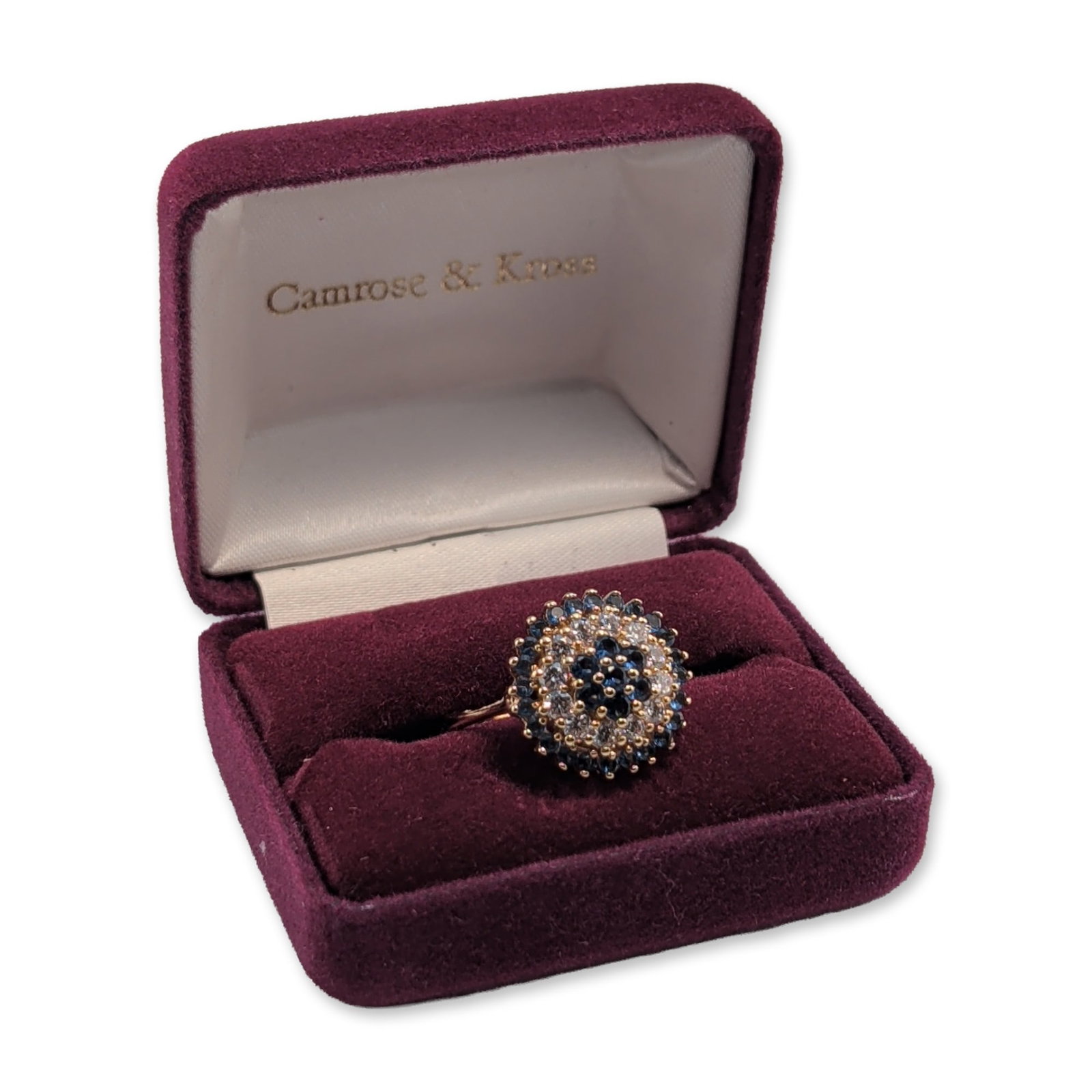 Camrose & Kross JBK Sapphire Style Cluster Ring: Camrose & Kross cocktail ring from the Jacqueline Kennedy Collection. The ring features a multi-tiered floral sunburst cluster design in gold-toned metal. The central tier is composed of round-cut