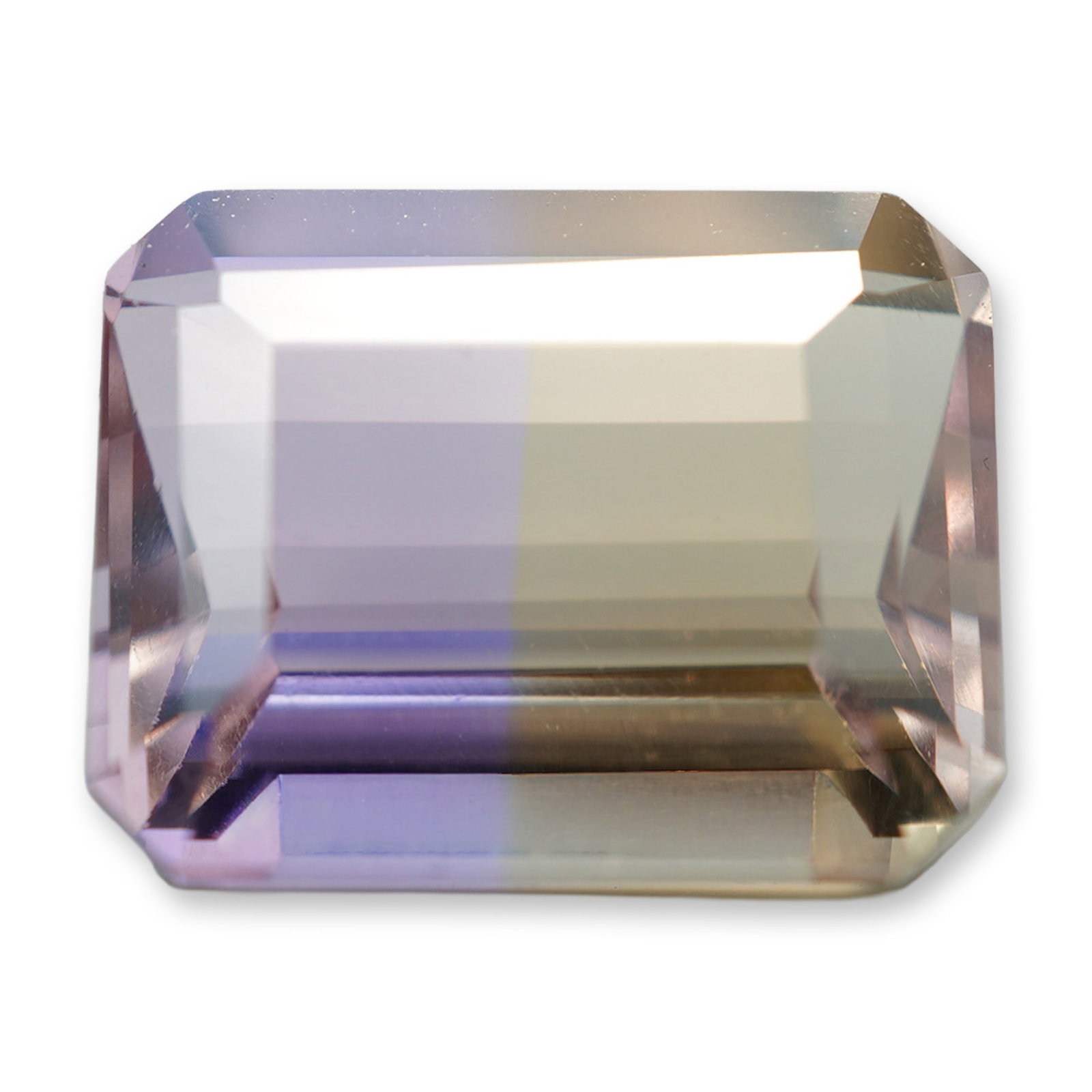 Octagonal Emerald Cut Bi-Color Ametrine Gemstone: Octagonal emerald cut ametrine gemstone. The stone displays characteristic bi-color zoning with a distinct split between pale purple and light golden-yellow sectors. Cut in a rectangular step pattern