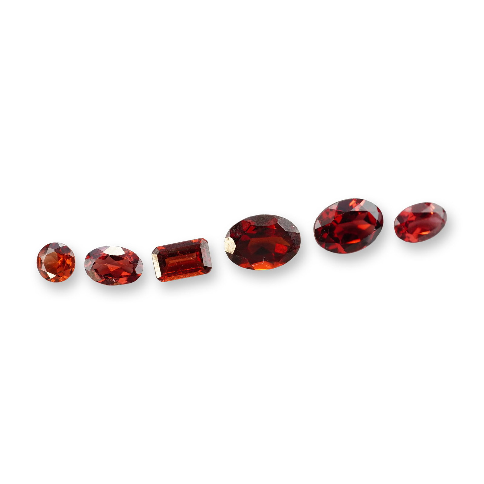 6pc Red Garnet Gemstones in Vatious Shapes and Sizes: Grouping of 6 garnet gemstones. The spiritual meaning of a garnet centers on vitality, protection, and devotion. Known as a stone of passion and commitment, it is highly valued for grounding
