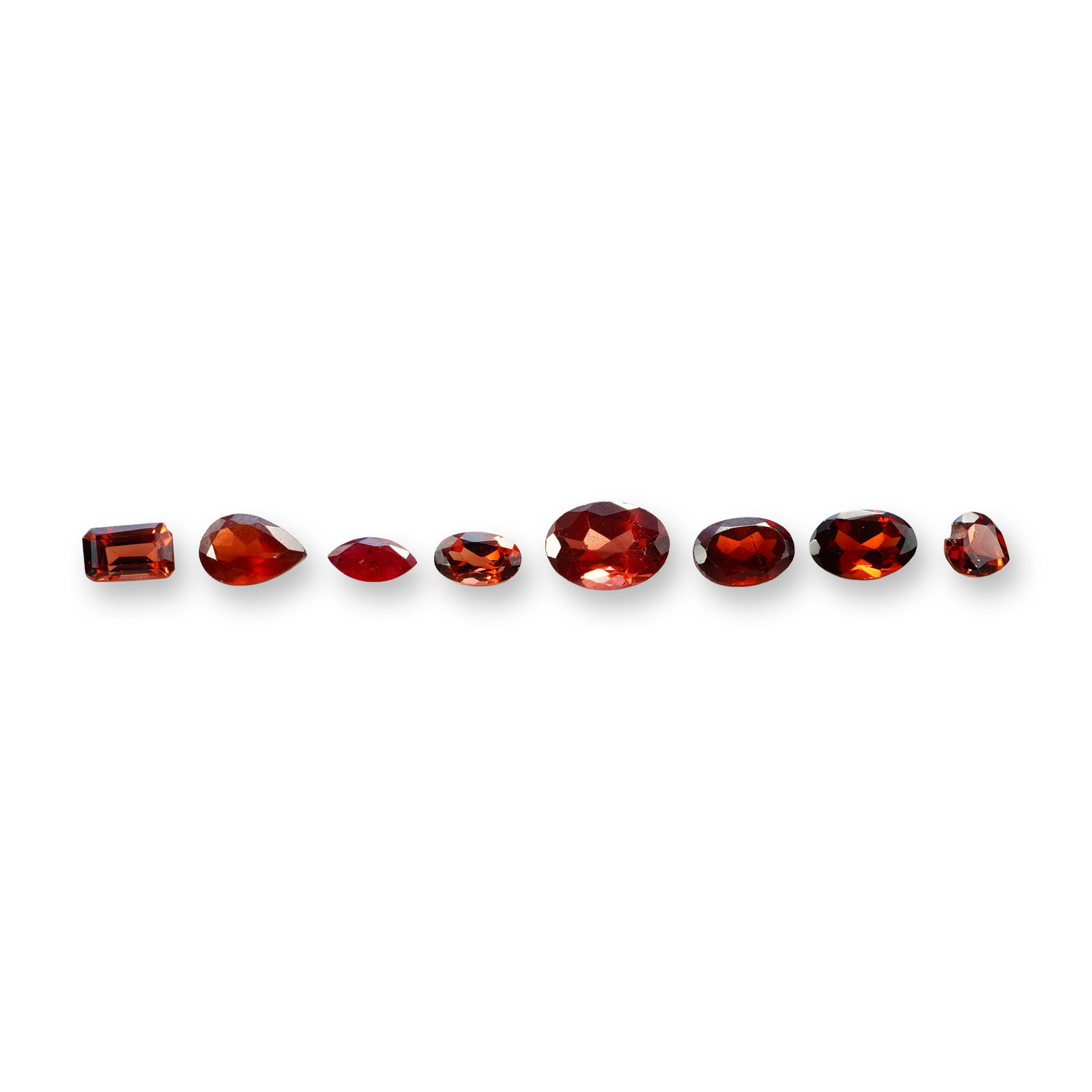 8pc Red Garnet Gemstones in Vatious Shapes and Sizes: Grouping of 8 garnet gemstones. The spiritual meaning of a garnet centers on vitality, protection, and devotion. Known as a stone of passion and commitment, it is highly valued for grounding