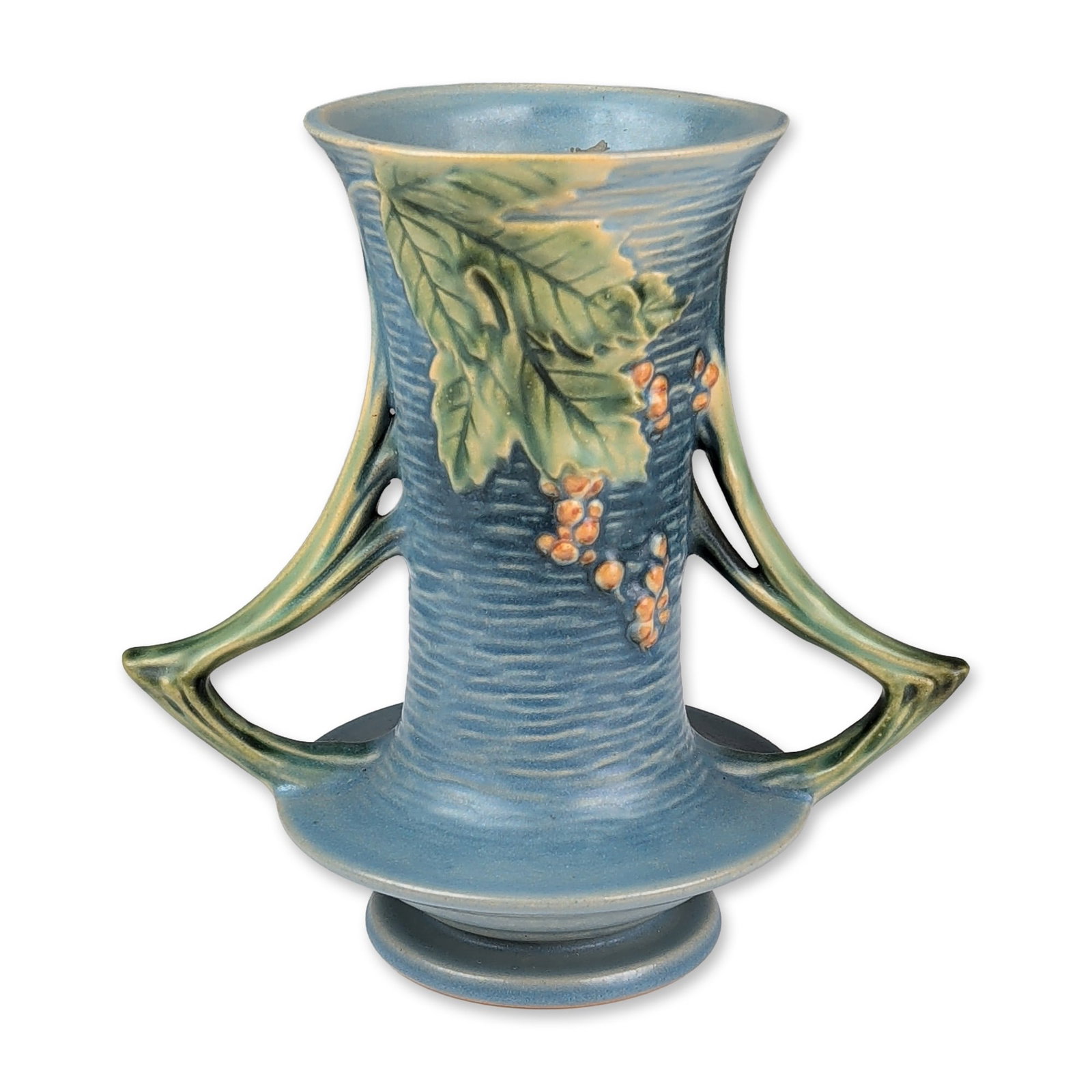 Roseville Pottery Dual Handled Vase, Bushberry Blue: Roseville art pottery double-handled vase in the Bushberry pattern, introduced in 1941. The earthenware vessel features a matte powder-blue glaze over a horizontally ribbed body. Decoration consists o