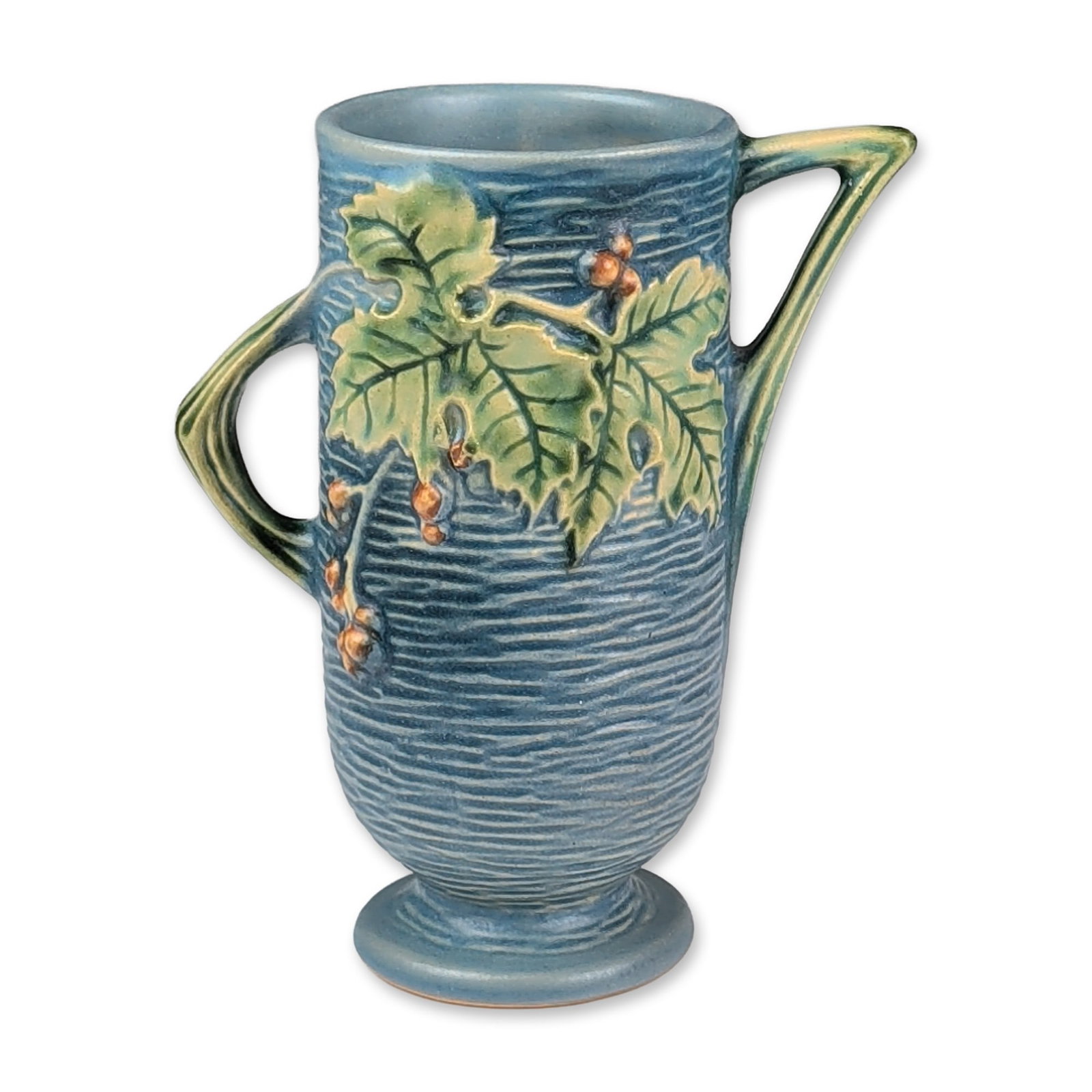 Roseville Pottery Vase, Blue Bushberry: Roseville art pottery two-handled vase in the Bushberry pattern, introduced in 1940. The earthenware body features a matte blue glaze with horizontal ribbing and relief-molded decoration of pointed gr