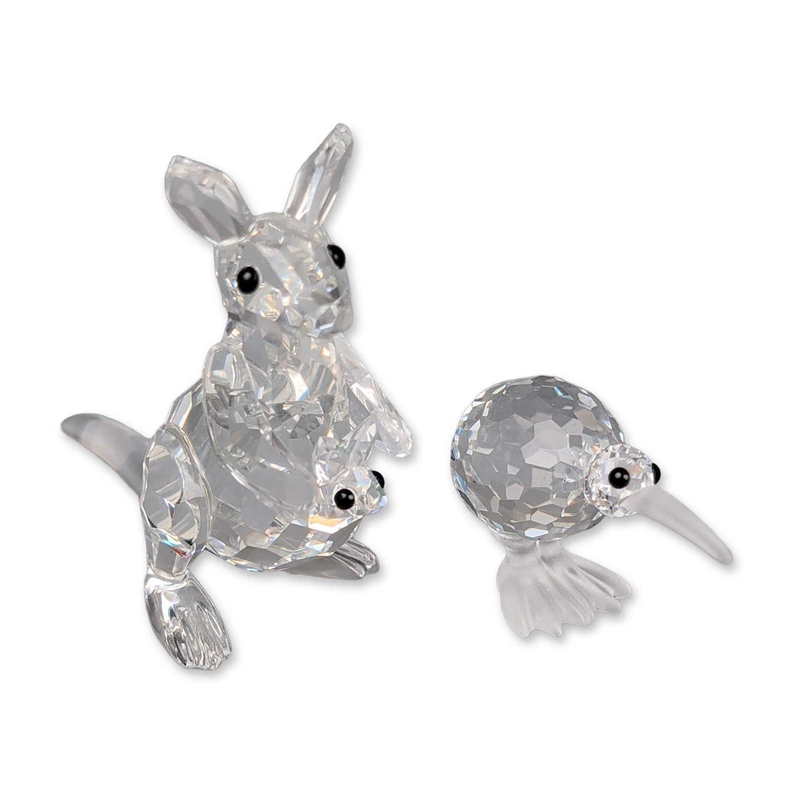 Two Swarovski Crystal Figurines, Mother Kangaroo with Joey and Kiwi: Swarovski Silver Crystal animal figurines, including a mother kangaroo with joey and a kiwi bird. The kangaroo features a faceted clear crystal body and head with black crystal eyes, and a smaller joe