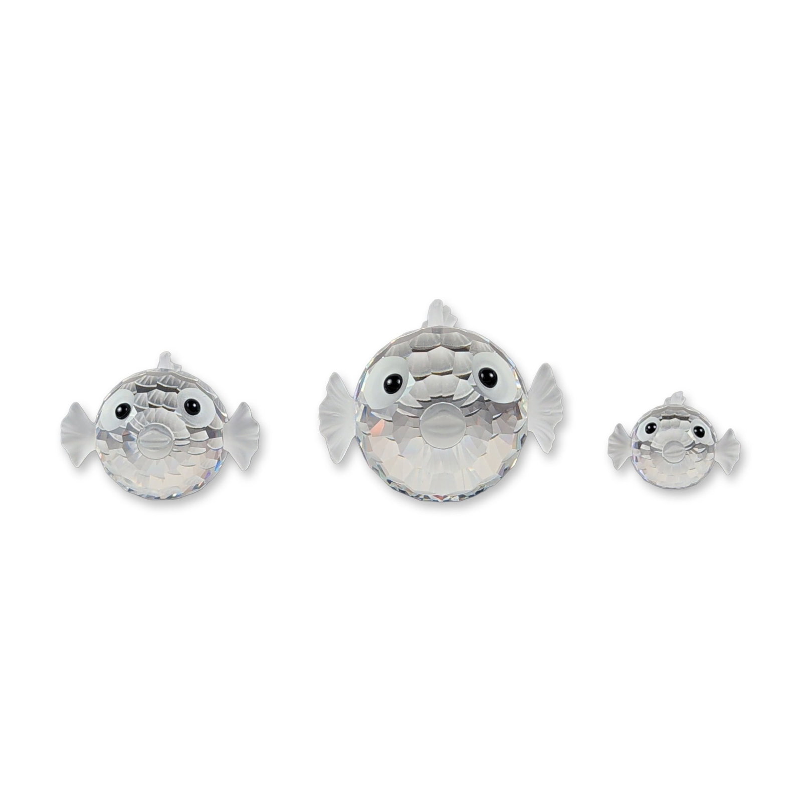 3pc Swarovski Silver Crystal Pufferfish Figurines: This collection consists of three graduated pufferfish figurines from Swarovski, crafted from faceted and frosted Austrian lead crystal. Each aquatic specimen features a spherical, multi-faceted body 
