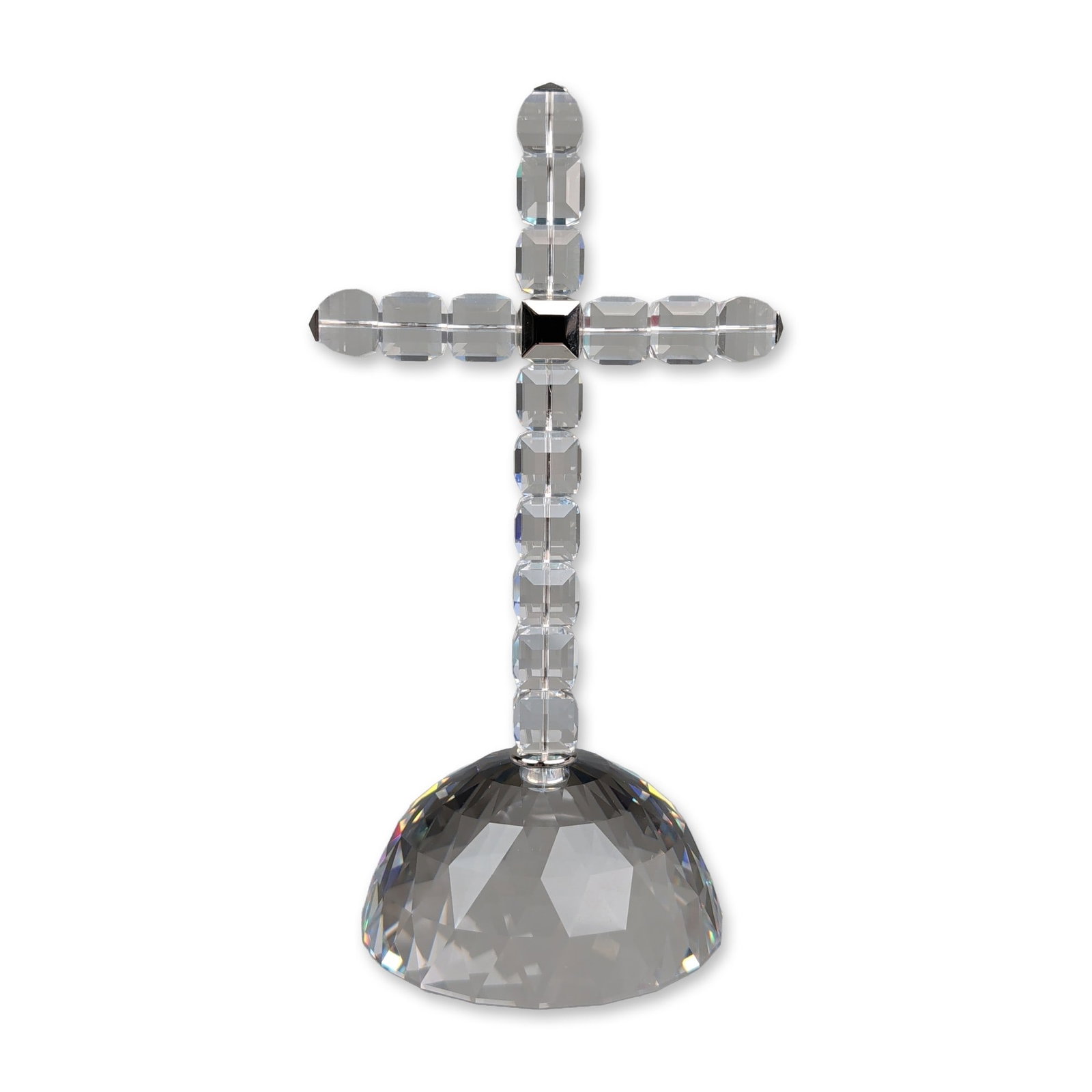 Swarovski Crystal Cross of Light Figurine: Swarovski lead crystal figurine, Cross of Light, designed by Stefano Ricci. The religious themed object features a cross form composed of individual faceted crystal blocks joined by a silver-toned cen
