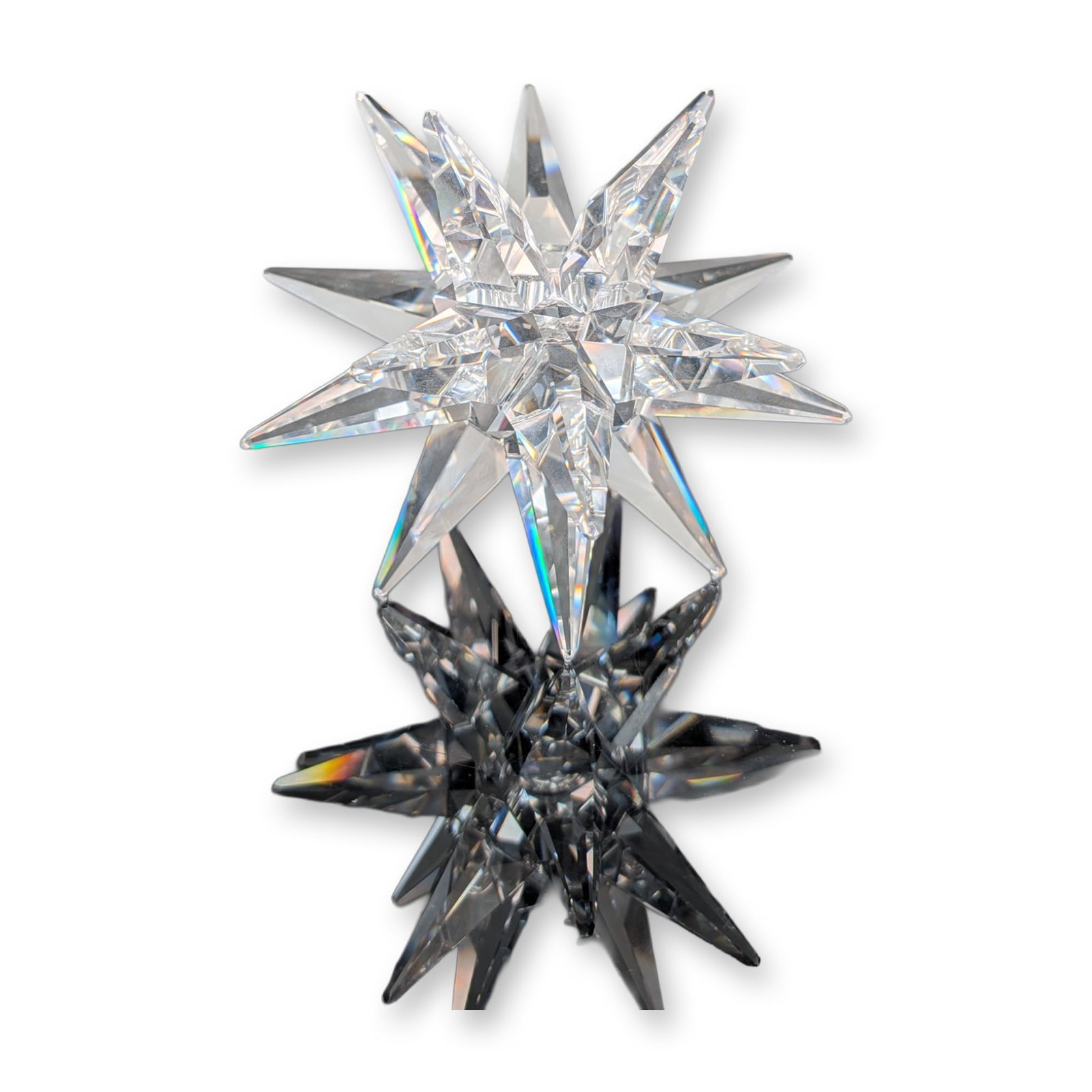 Swarovski Crystal Large Star Candle Holder: Swarovski Silver Crystal star-form candle holder in clear faceted lead crystal. The three-dimensional stellated sculpture features multiple sharp points radiating from a central circular recession des