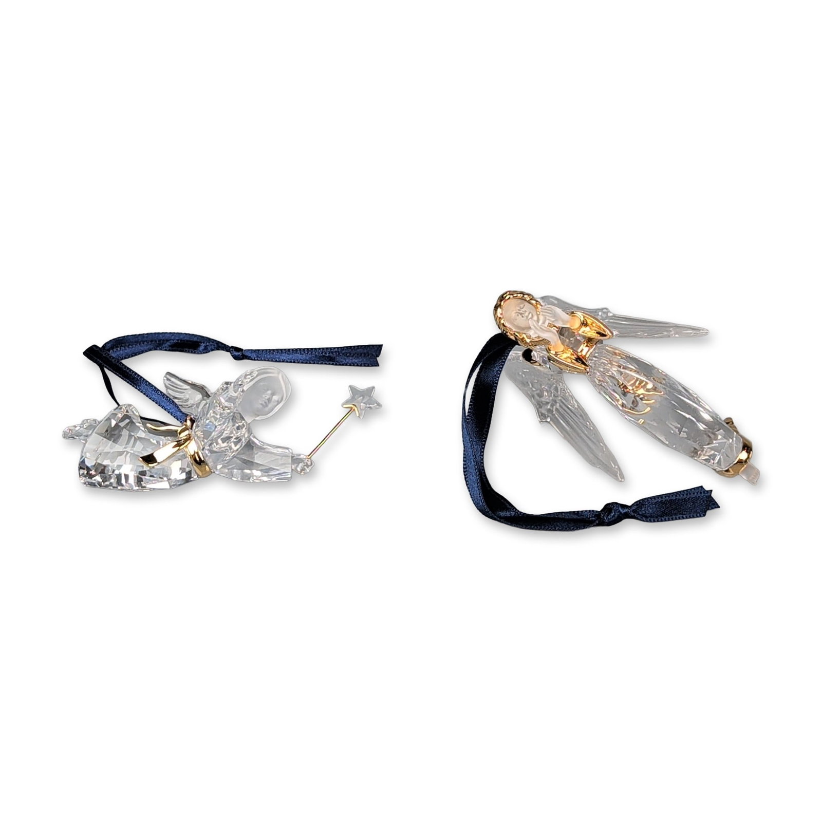 Two Swarovski Crystal Angel Ornaments: Angel ornaments features a soaring angel with gold-tone metal accents for the hair, wing attachments, and feet. The second ornament from the Crystal Memories collection consists of a flying angel with