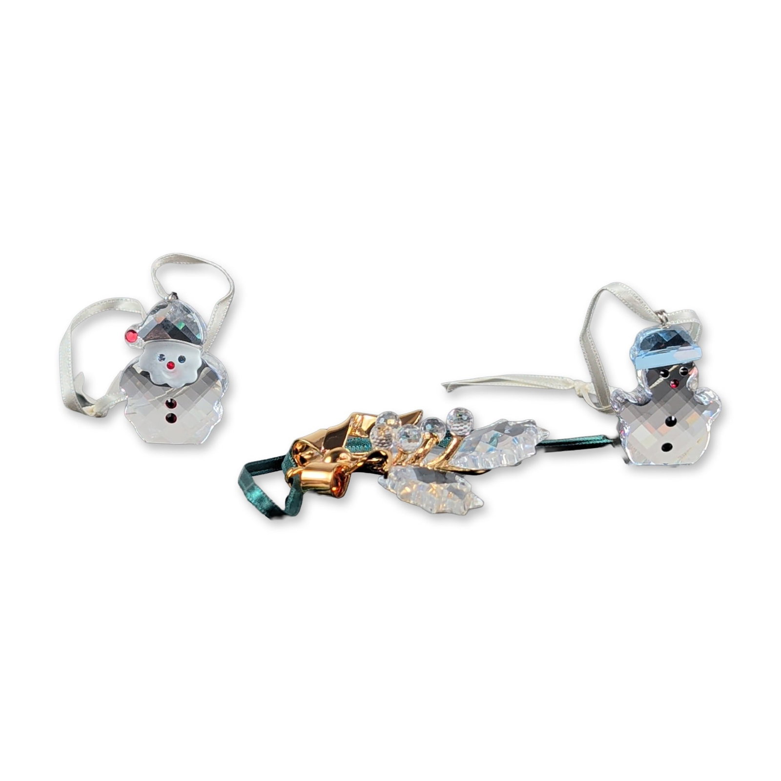 3pc Swarovski Crystal Holiday Ornaments: Swarovski. 3pc faceted lead crystal holiday ornaments. The group includes a snowman with a blue faceted crystal hat and black bead accents; a Santa with red crystal accents and black bead buttons; and