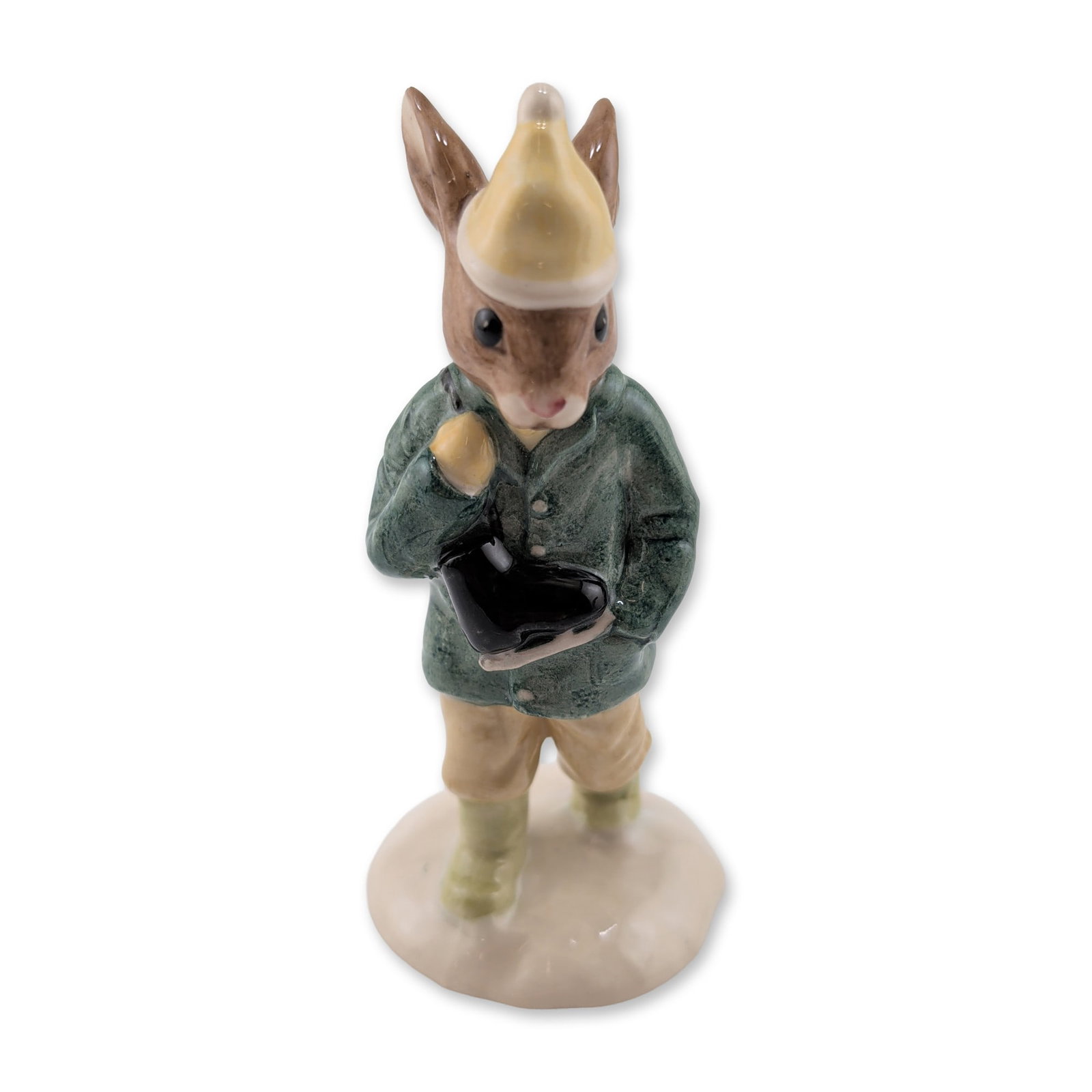 Royal Doulton Bunnykins Boy Skater Figurine: Royal Doulton, England. Boy Skater Bunnykins figurine in glazed porcelain, model DB 152. The piece depicts a rabbit character in winter attire, featuring a dark green jacket, tan trousers, and a cream