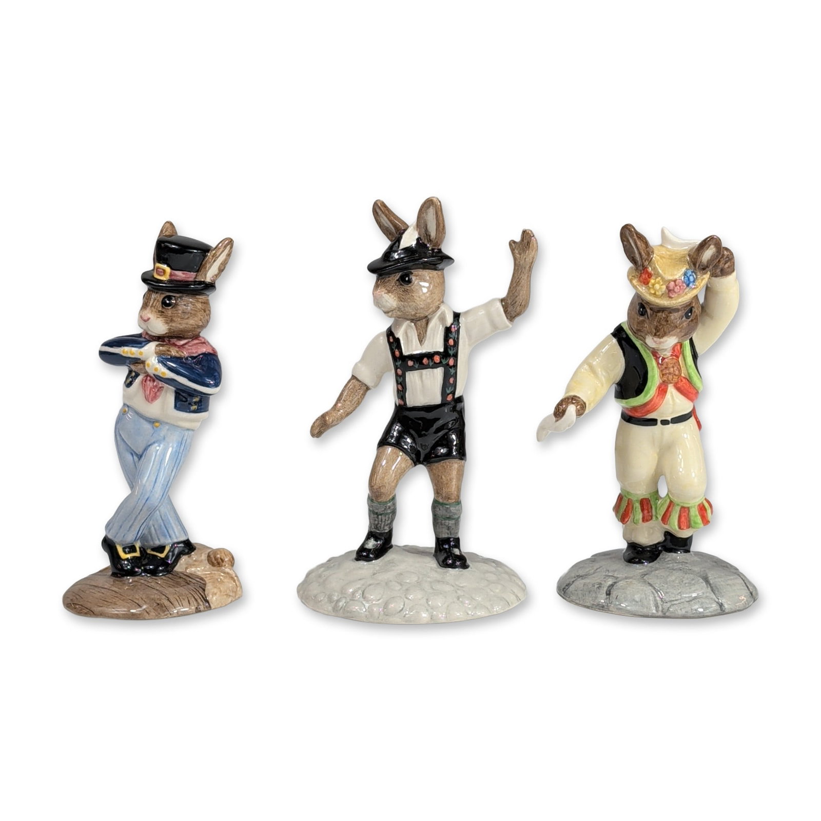 3pc Royal Doulton Bunnykins Porcelain Figurines: Royal Doulton. Trio of hand-painted glazed porcelain figurines from the Bunnykins collection, each depicting a rabbit in traditional dance attire. The group includes a Morris Dancer (DB 204) released 