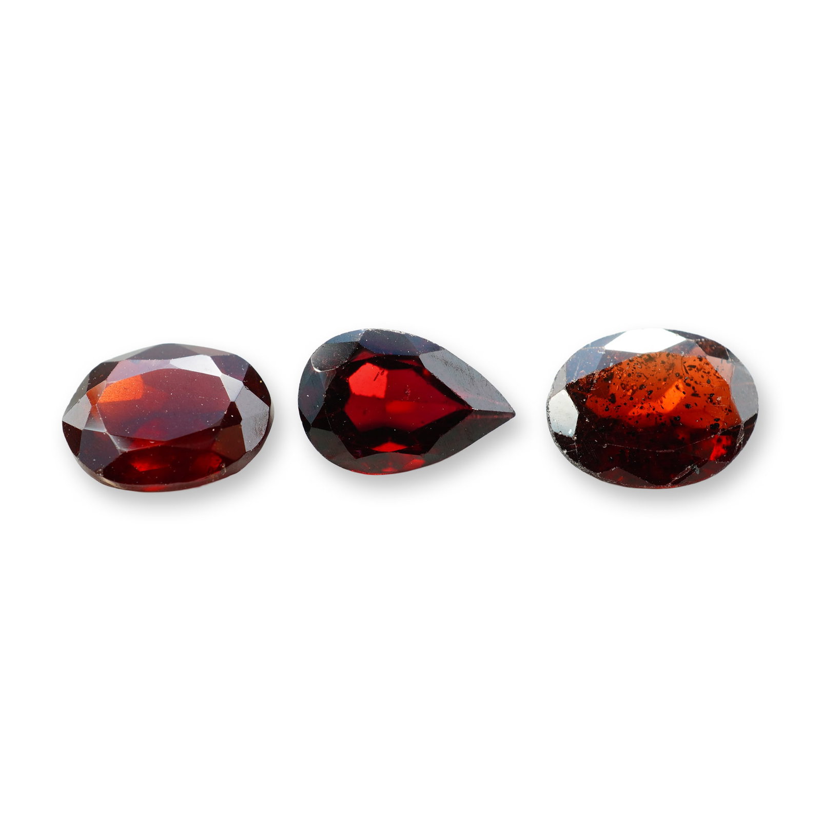 4pc Red Garnet Gemstones in Vatious Shapes and Sizes: Grouping of 4 garnet gemstones. The spiritual meaning of a garnet centers on vitality, protection, and devotion. Known as a stone of passion and commitment, it is highly valued for grounding scattered