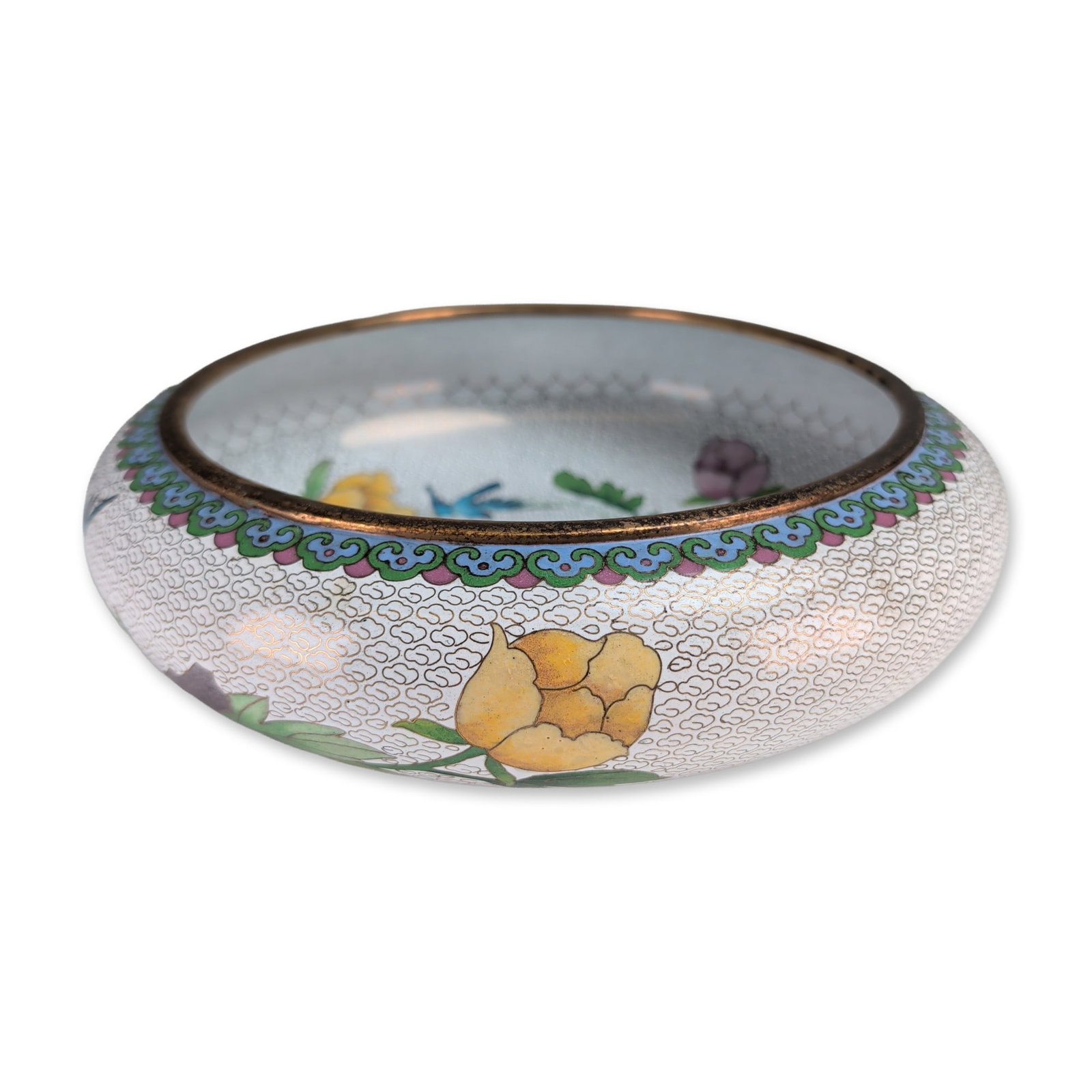Chinese White Ground Cloisonne Enamel Floral Bowl: Chinese cloisonne enamel bowl featuring a white wirework cloud scroll ground decorated with multi-petaled peony blossoms in shades of cobalt blue, pink, and white. The interior includes a small blue b