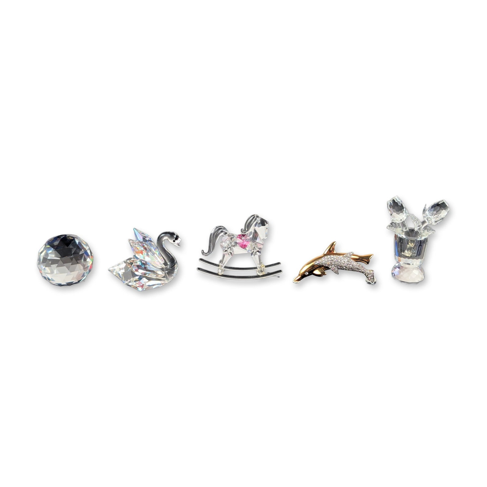 Group of 5 Swarovski and Specialty Lead Crystal Figurines: Collection of faceted lead crystal figurines including a swan with wings featuring an iridescent finish, a rocking horse with a pink heart-shaped crystal detail, a vase of roses containing two faceted