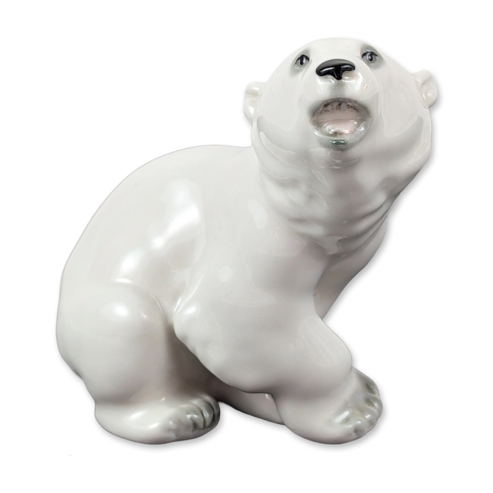 Lomonosov USSR Porcelain Polar Bear Figurine: Soviet Lomonosov Porcelain Factory (LFZ) figurine of a seated polar bear in white glazed porcelain. The figure is modeled in a begging pose with an upturned head and open mouth, featuring hand-painted