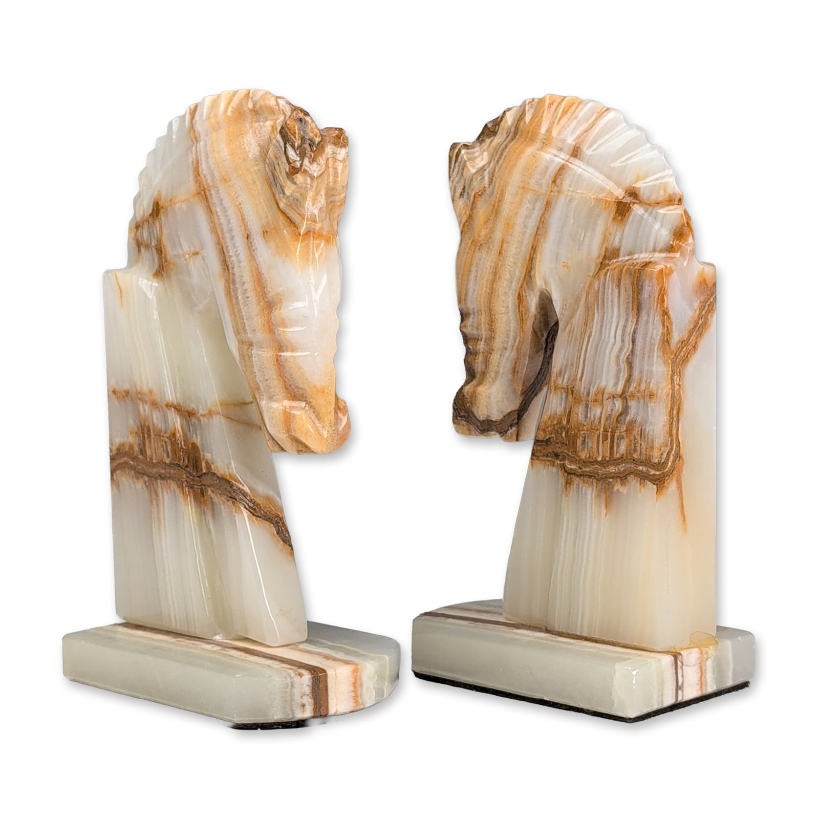 Pair of Carved Onyx Horse Head Bookends: Mid-Century Modern style pair of bookends in carved banded onyx, featuring stylized horse head motifs. The stone displays characteristic horizontal layering in translucent white, cream, and brown tone