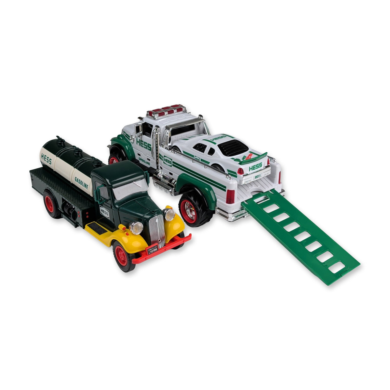 Two Hess Toy Trucks, The First Hess Truck and Truck with Race Car Set: Hess. Pair of toy truck sets in plastic and chrome-plated accents. The first item is a replica of the 1933 Hess tanker delivery vehicle featuring a dark green cab, yellow fenders, a white tank, and re