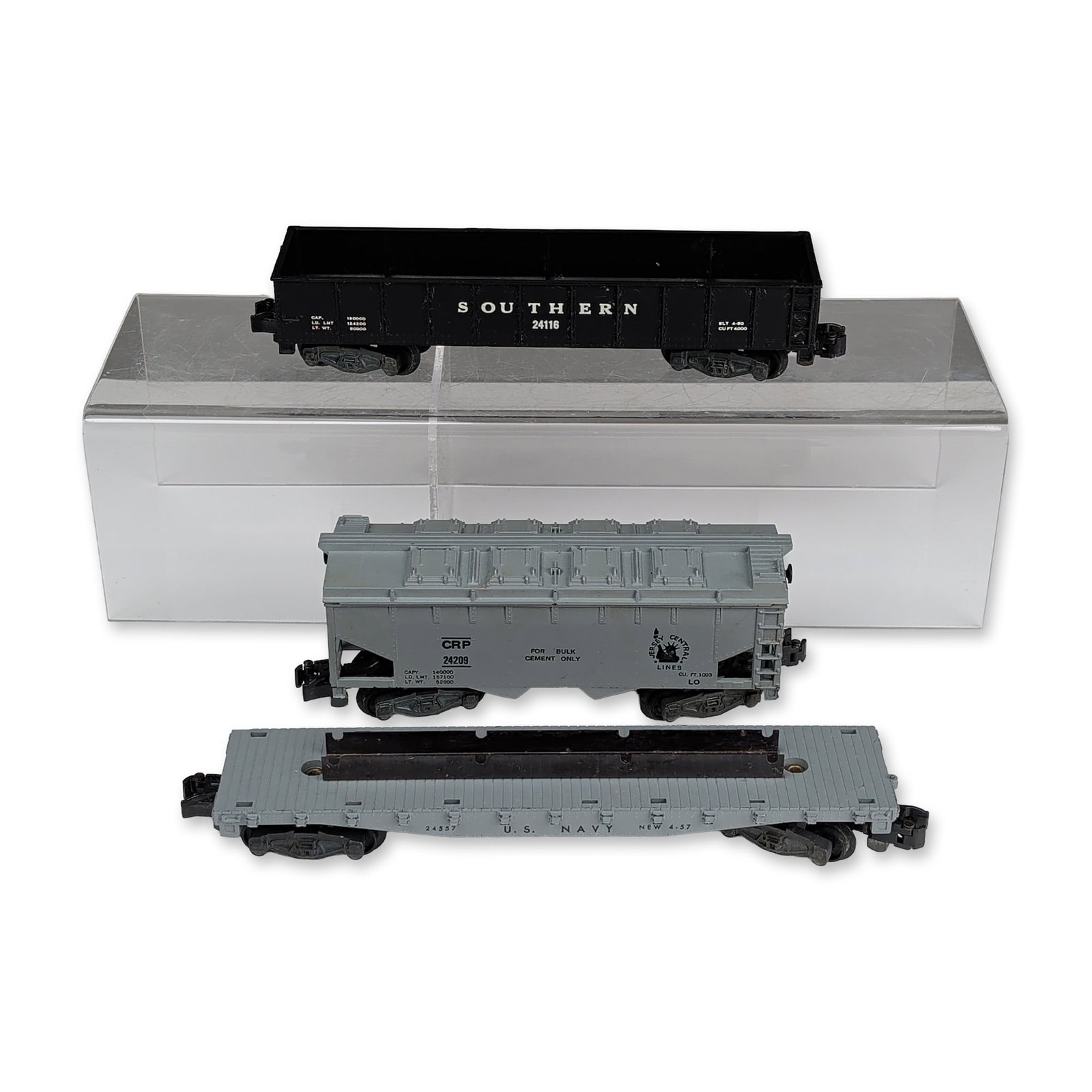 Three Gilbert American Flyer 3/16 Scale Trains, Gondola, Jeep Transport & Cement Car: A.C. Gilbert Company, American Flyer. Group of three S-gauge model railroad freight cars with original boxes, including a Southern Railway gondola, a Jersey Central Lines covered hopper, and a U.S. Na