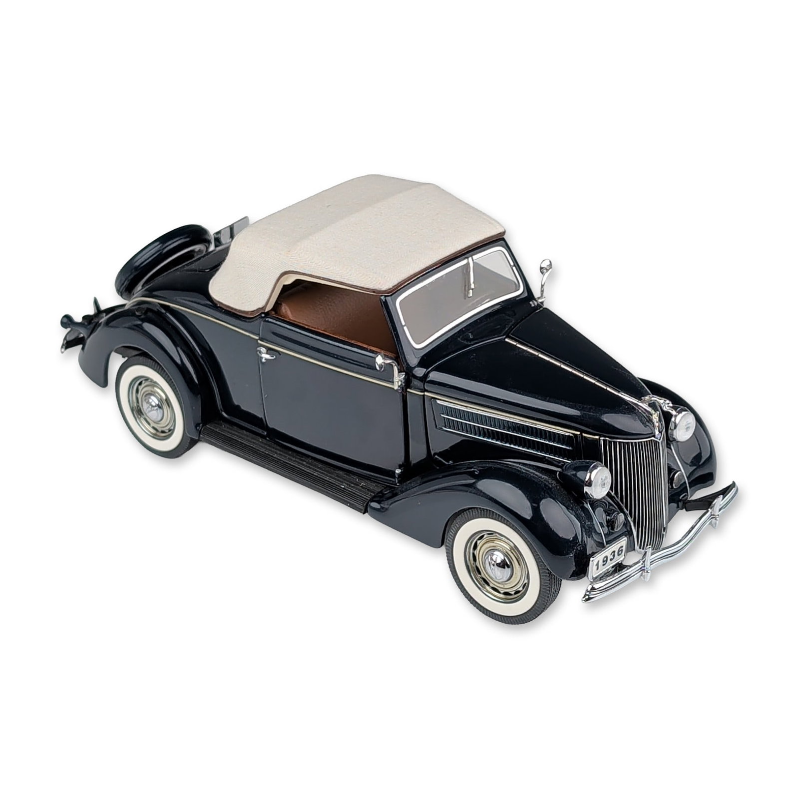 Danbury Mint 1936 Ford DeLuxe Cabriolet Convertible Replica Car: The Danbury Mint precision model car of a 1936 Ford DeLuxe Cabriolet. The die-cast metal body features a gloss black finish accented with chrome-plated trim, bumpers, and hubcaps on whitewall tires. F