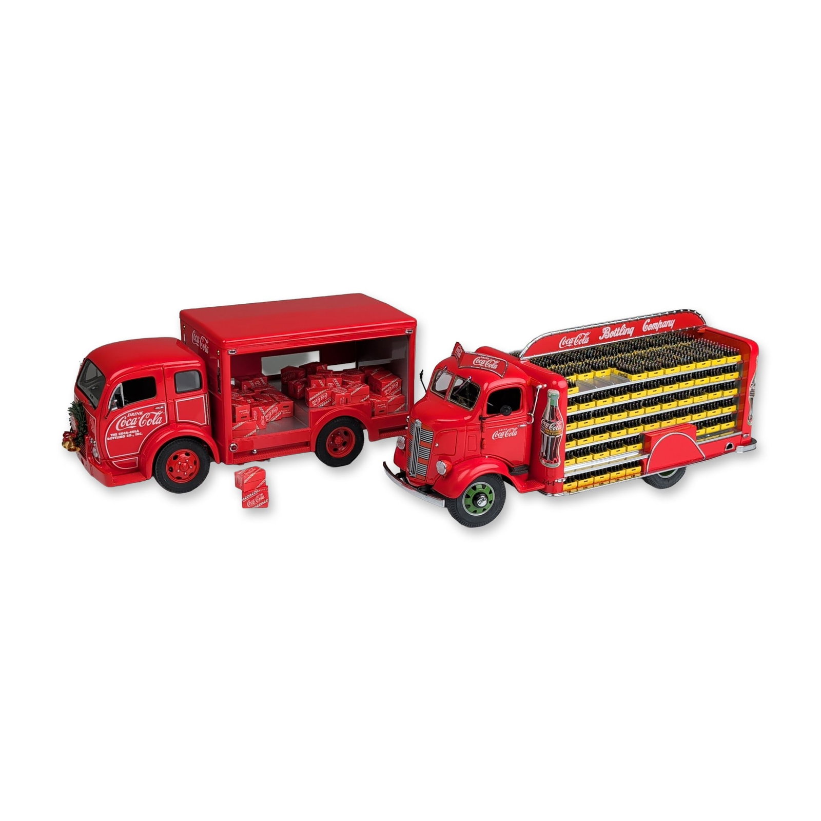 Two Danbury Mint Coca-Cola Delivery and Christmas Delivery Model Trucks, with Loose Bottle Crates: Two 1:24 scale model delivery vehicles manufactured by The Danbury Mint for the Coca-Cola Bottling Company, constructed of die-cast metal and plastic components. The first vehicle is a 1938 bottle del
