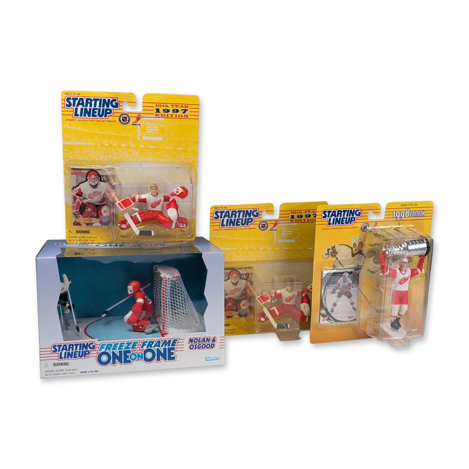 4pc Kenner Starting Lineup NHL Figures and Playset: A collection of four factory-sealed Kenner Starting Lineup NHL collector action figures and one Freeze Frame One on One playset from the late 1990s. The grouping includes two 1997 edition Detroit Red 