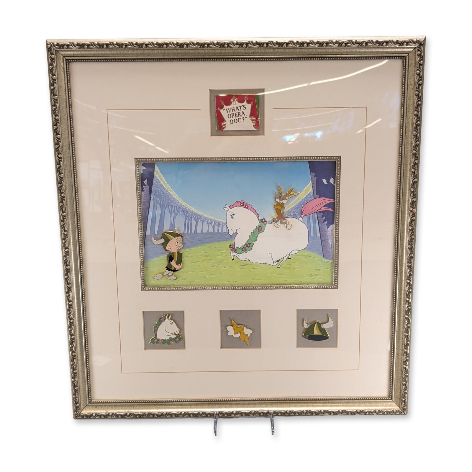 Warner Bros. Studio Store "What's Opera, Doc?" Lithograph and Pin Set: Warner Bros. Studio Store Gallery commemorative set issued in 1999, featuring a central color lithograph and six enamel-on-brass pins based on the 1957 animated short "What's Opera, Doc?". The lithogr