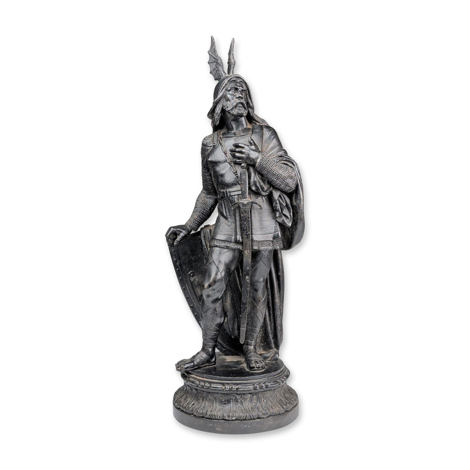 Late 19th Century Inspired Historicist Cast Metal Medieval Knight Sculpture: Cast metal sculpture of a medieval knight with a dark patinated finish. The figure is modeled with a full beard and a winged helmet, wearing a chainmail hauberk under a belted tunic with a sword in it