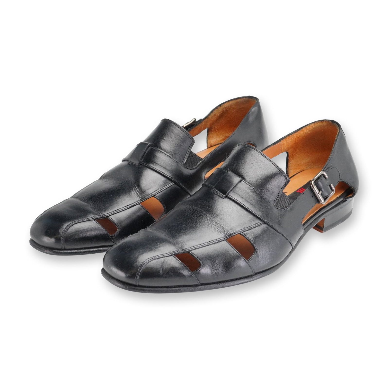 Pair of Mezlan Handel Leather Dress Sandals: Pair of Mezlan Handel black leather dress sandals featuring a closed-toe and closed-back design with cut-out side panels. Styled with a single monk strap secured by a polished silver-tone buckle closu