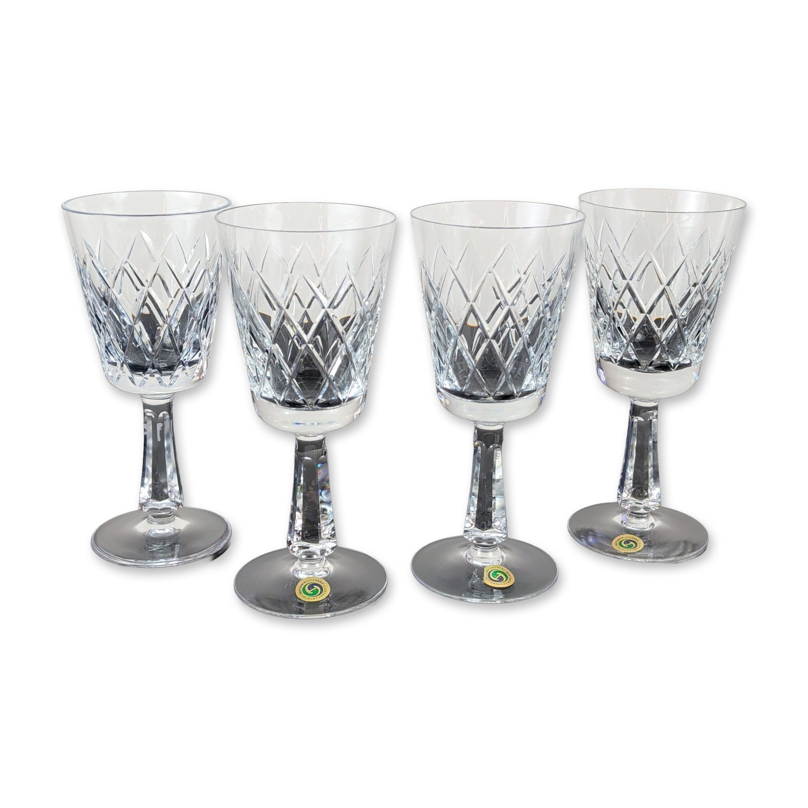 4pc Clontarf Crystal Irish Wine Goblets: Clontarf Crystal, Ireland. Set of four wine goblets in hand-cut crystal. Each piece features a trumpet-shaped bowl decorated with a diamond-cut lattice pattern over vertical wedge cuts. The bowls are 