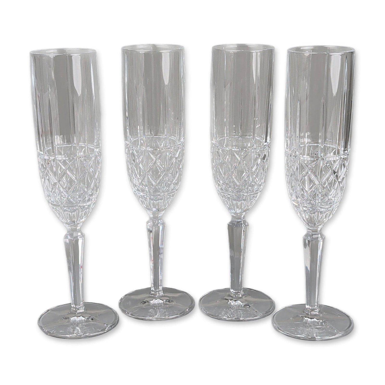 4pc Marquis by Waterford Crystal Champagne Flutes, Markham: Marquis by Waterford. Set of four champagne flutes in lead crystal, each featuring a deep-cut bowl with vertical wedge cuts positioned over a wide band of diamond cross-hatching. The glasses are