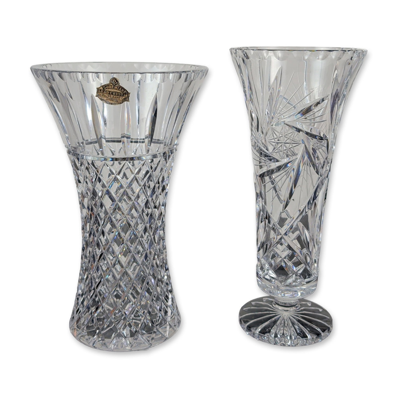 2pc Bohemian Hand Cut Crystal Vases: Bohemian. Two vases in hand-cut lead crystal, featuring a flared trumpet form and a cylindrical pedestal form. The trumpet vase is decorated with vertical miter flutes over a lower register of diamond