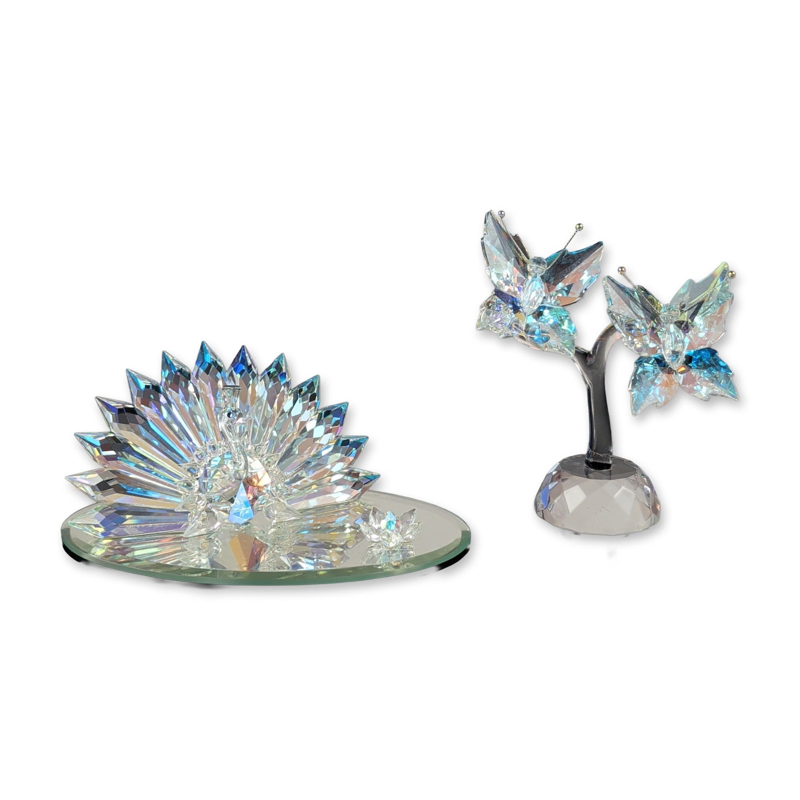 2pc Crystal Images Faceted Crystal Figurines: This crystal pair features two decorative wildlife specimens from the Crystal Images product line, consisting of a butterfly branch and a peacock arrangement. The butterfly piece features a clear cent