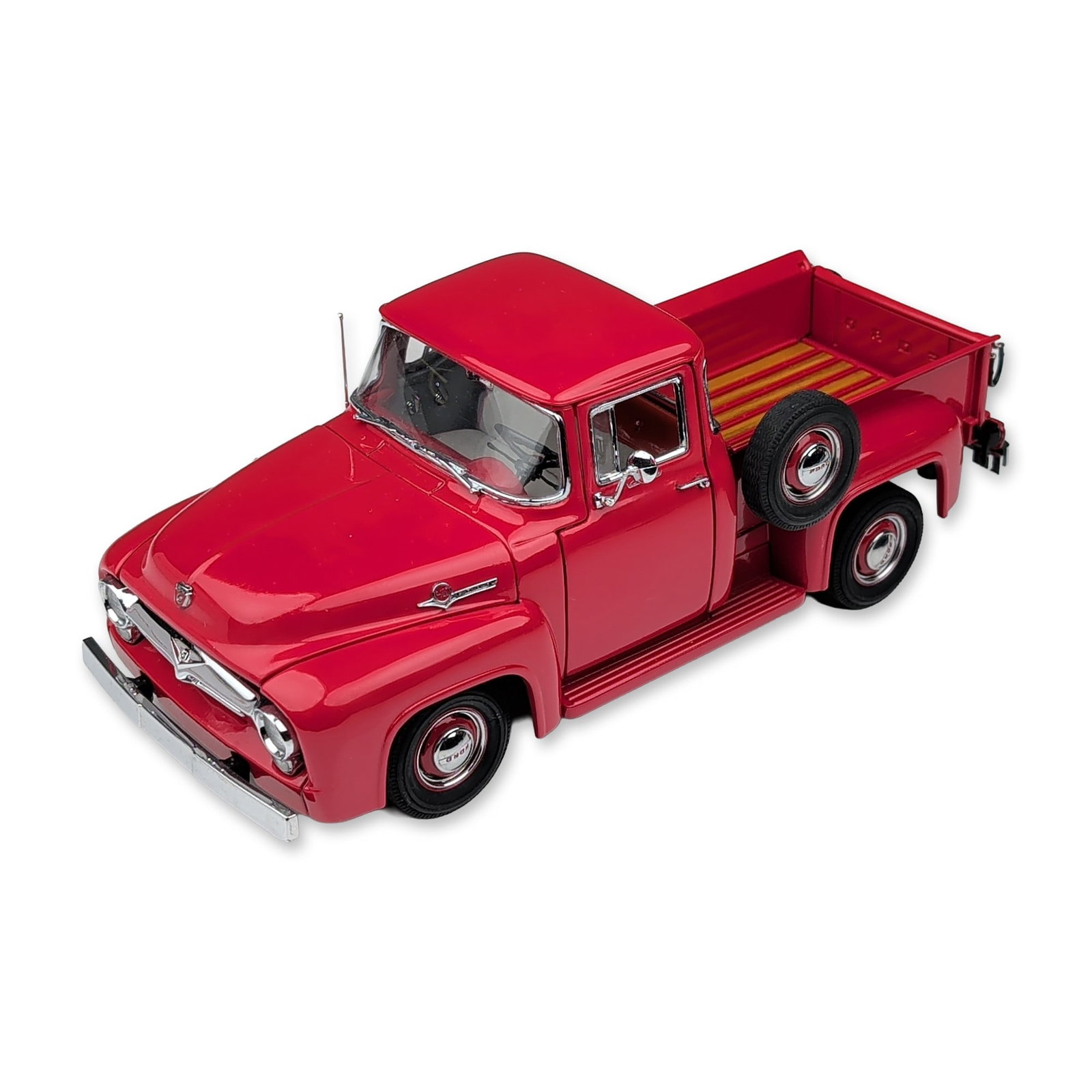 Danbury Mint 1956 Ford F-100 Die-Cast Pickup Replica: The Danbury Mint 1:24 scale die-cast model of a 1956 Ford F-100 pickup truck. The vehicle is finished in red with a highly detailed interior and a wood-plank style truck bed featuring metal dividers. 