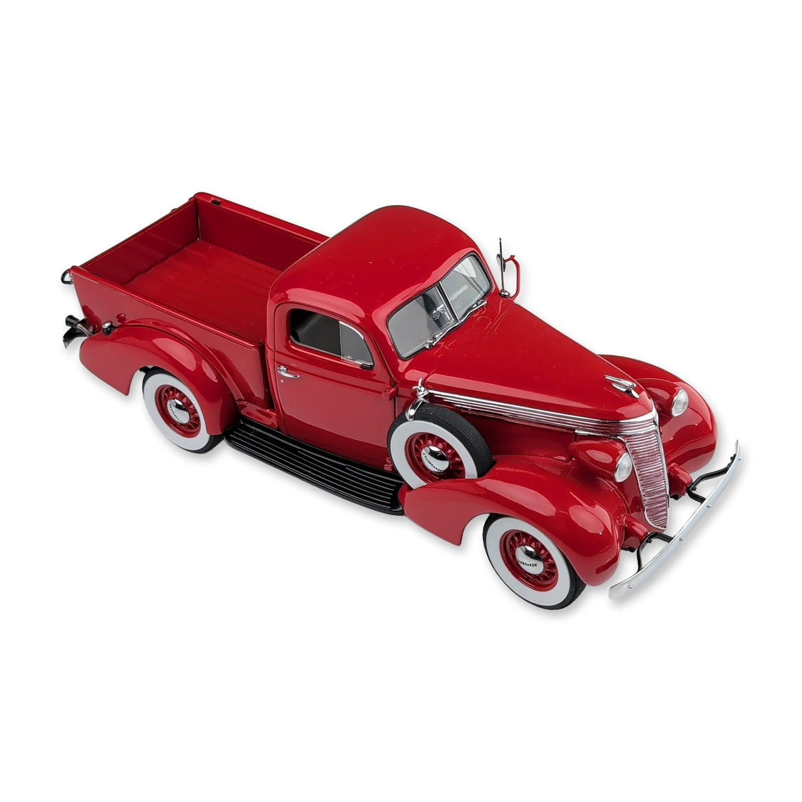 Franklin Mint Precision Models 1937 Studebaker Pickup Replica: 1937 Studebaker Pickup 1:24 scale die-cast model vehicle. The truck features a red paint finish with black running boards and white-wall tires, including a side-mounted spare tire. Construction featur