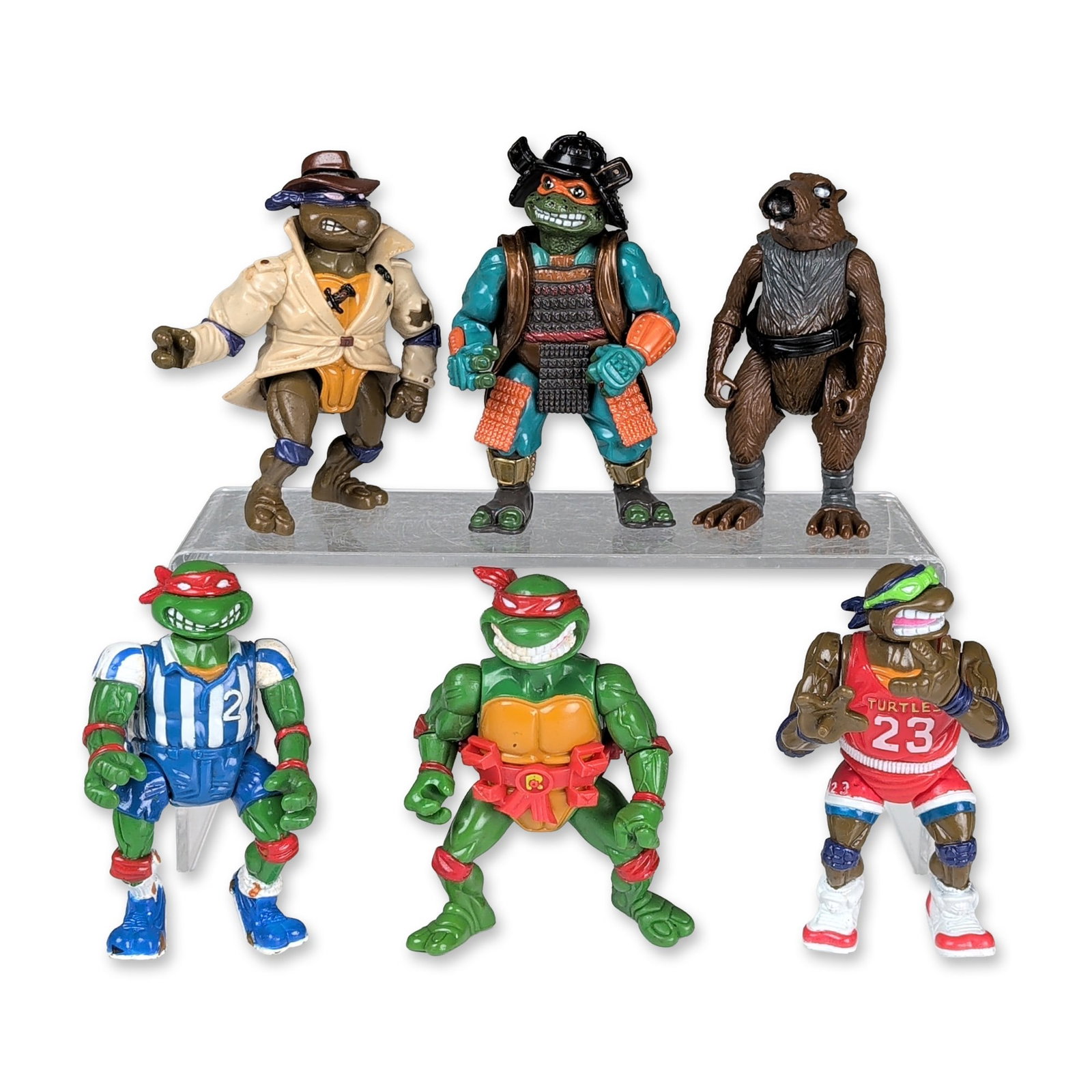 6pc Playmates TMNT Action Figures: Playmates Toys. Collection of six vintage action figures in molded plastic, representing various themed series from the Teenage Mutant Ninja Turtles franchise. The group includes an Undercover Donatel